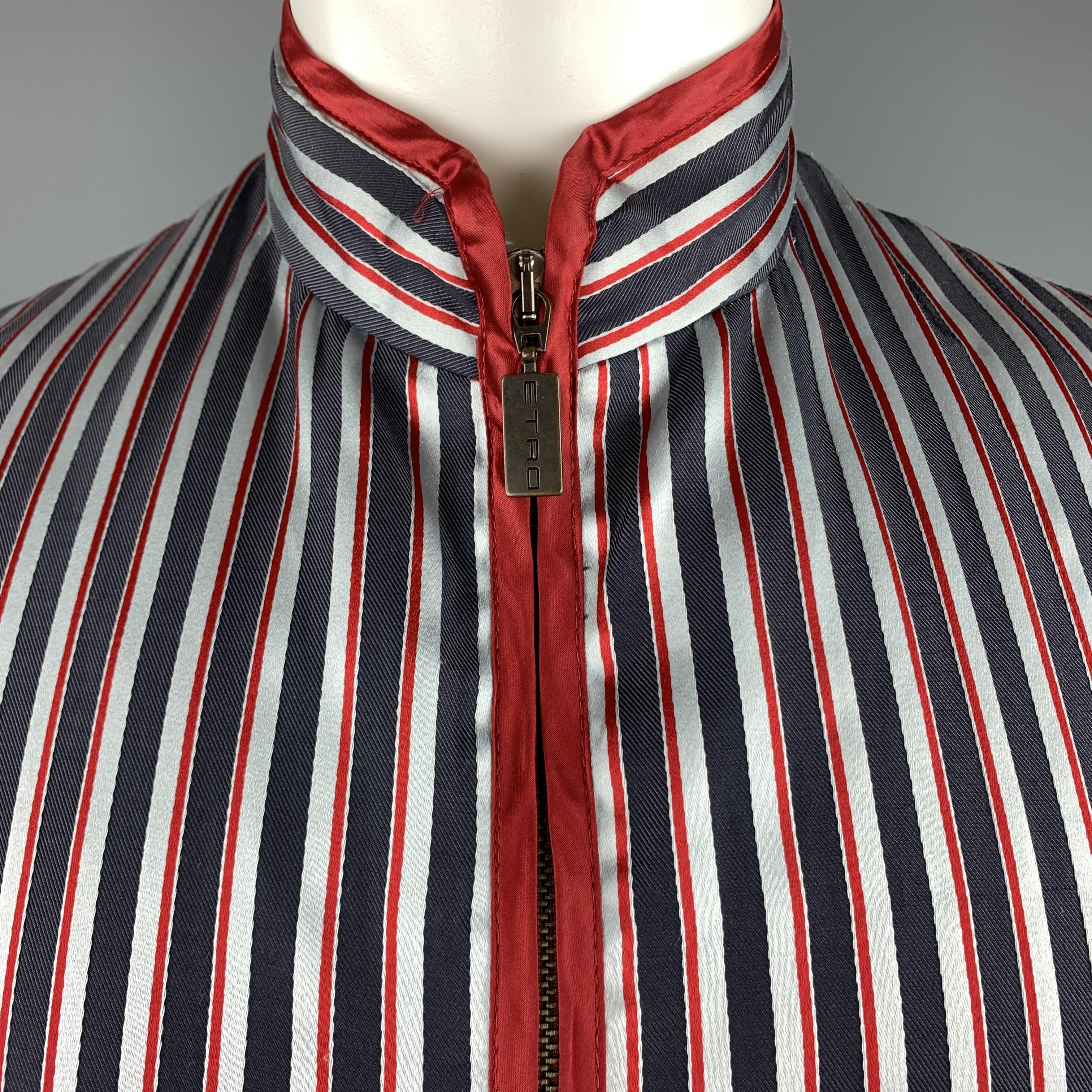 ETRO zip vest comes in light blue and navy striped satin with a high neck collar and burgundy satin piping. Made in Italy.

Excellent Pre-Owned Condition.
Marked: M

Measurements:

Shoulder: 15 in.
Chest: 42 in.
Length: 23 in.