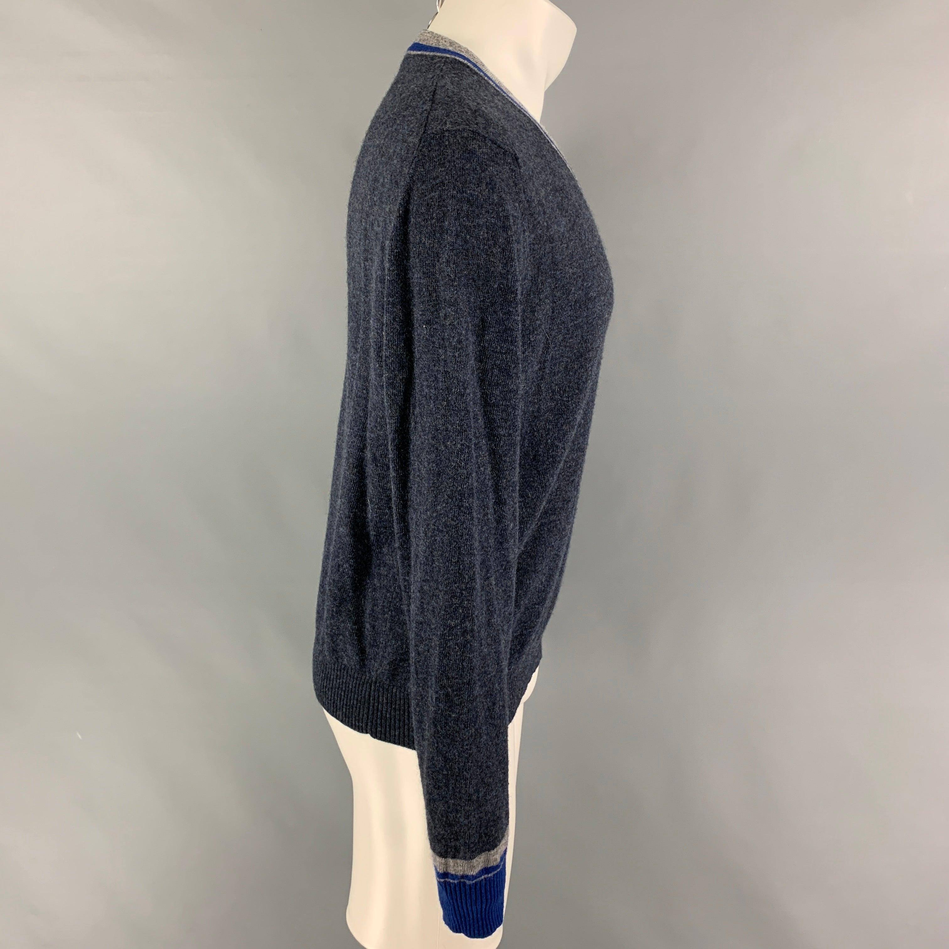 ETRO pullover comes in a blue & grey heather wool featuring a v-neck. Made in Italy.
Very Good
Pre-Owned Condition. Small hole at left shoulder.  

Marked:   M  

Measurements: 
 
Shoulder: 16 inches  Chest:
40 inches  Sleeve: 26.5 inches  Length: