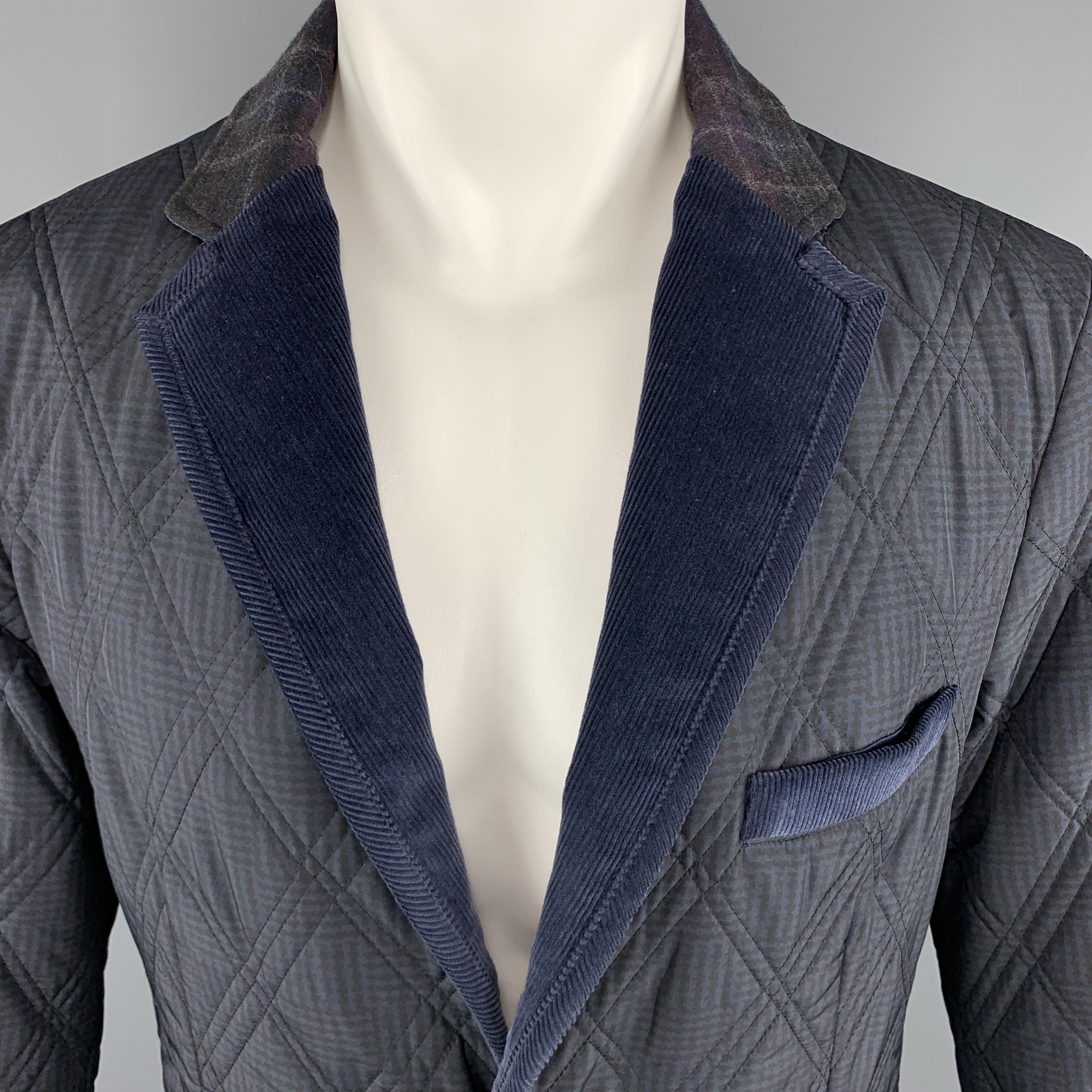 ETRO Jacket comes in navy tones in a quilted nylon and corduroy materials, with a notch lapel, slit and flap pockets, elbow patches, two buttons at closure, single breasted, buttoned cuffs and a double vent at back. Made in Italy.

Excellent