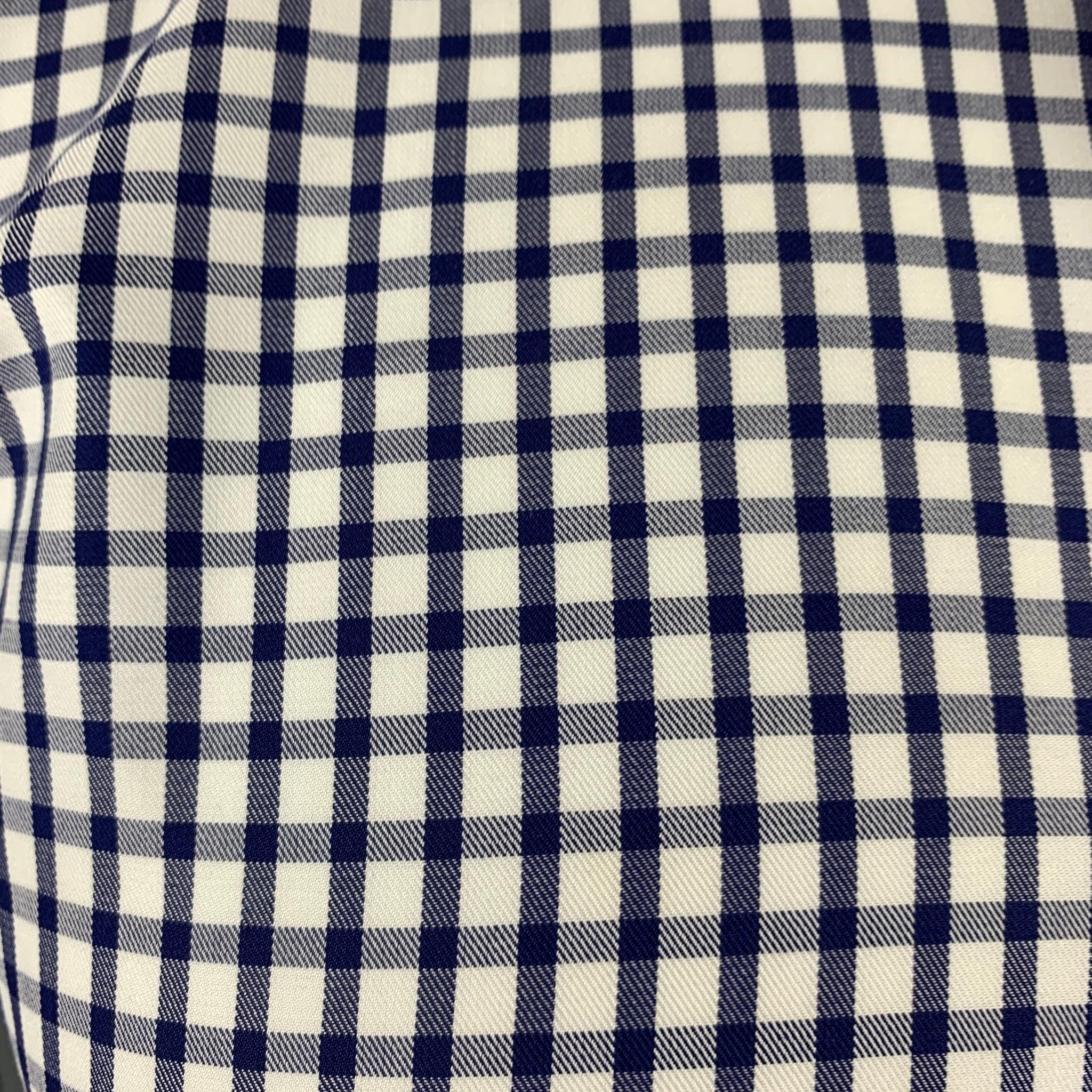 ETRO long sleeve shirt in a blue and white fabric featuring all over checkered pattern, one button angle cuffs, and a button closure. Made in Italy.Very Good Pre-Owned Condition. Signs of wear on collar. 

Marked:   IT 39 

Measurements: 
