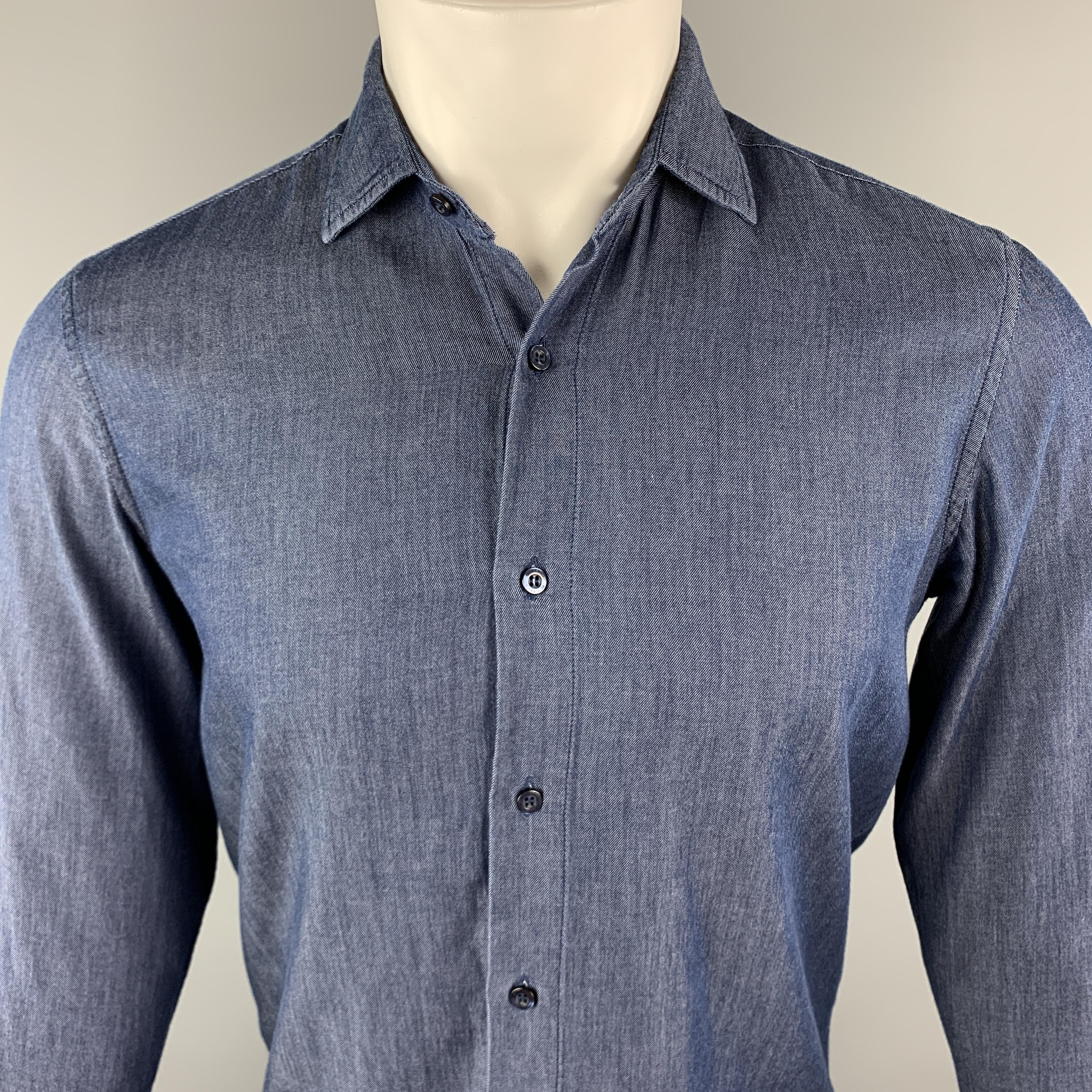 ETRO Long Sleeve Shirt comes in an indigo tone in a solid cotton material, featuring a button up style and a spread collar, with buttoned cuffs. Made in Italy.

Excellent Pre-Owned Condition.
Marked: S

Measurements:

Shoulder: 16 in. 
Chest: 40 in.