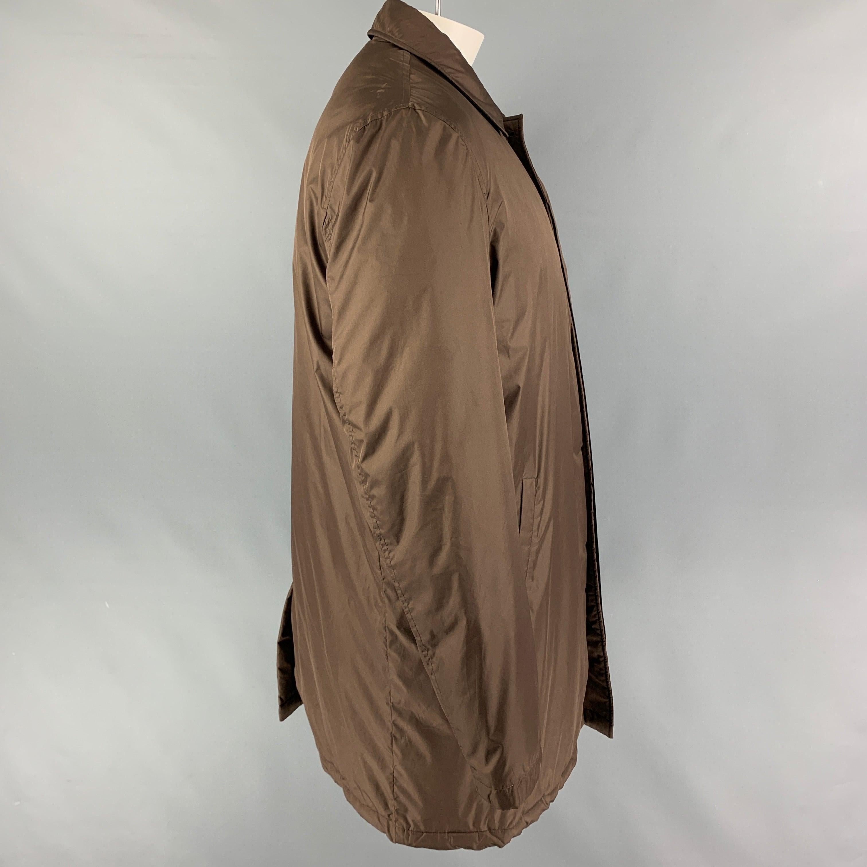 ETRO coat comes in a brown polyester / cotton with a stripe print liner featuring a spread collar, single back slit, and a hidden placket closure. Made in Italy.
Very Good
Pre-Owned Condition. 

Marked:  XL 

Measurements: 
 
Shoulder: 20 inches