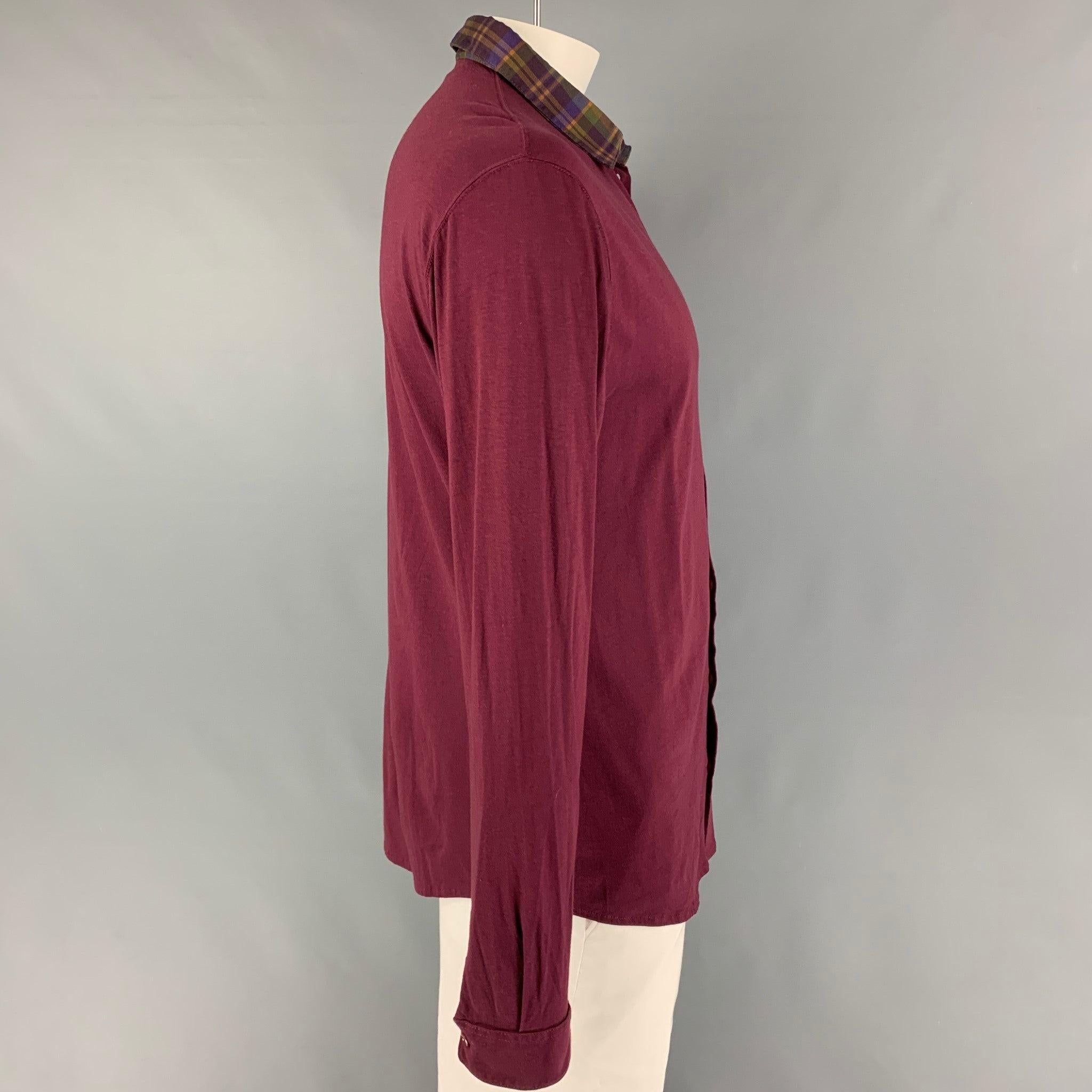 ETRO long sleeve shirt comes in a burgundy cotton featuring a plaid spread collar, embroidered logo, and a buttoned closure. Made in Italy.
Very Good
Pre-Owned Condition. 

Marked:   XL  

Measurements: 
 
Shoulder: 19 inches  Chest: 44 inches 