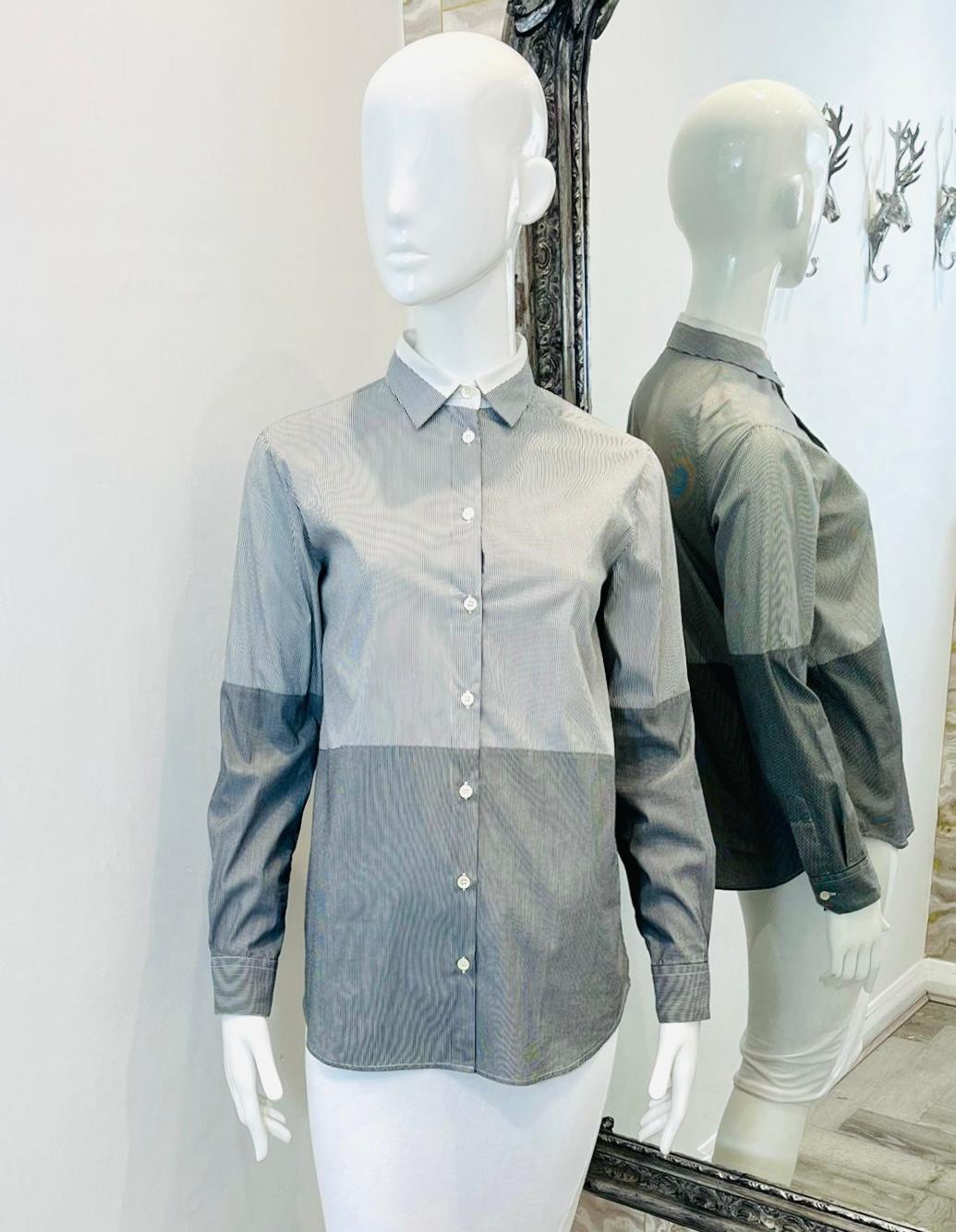 Camicia in cotone a righe di Etro

Camicia grigia dal taglio classico con pannelli a contrasto grigio chiaro e grigio scuro.

Dettagliato con sottili strisce verticali su tutta la superficie.

Whiting: colletto con bordi bianchi, maniche lunghe e