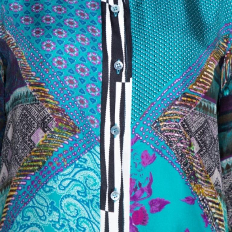 Etro makes the most stylish shirts with creative designs. This creation is made from a silk blend and features a floral print all over it. It also has long sleeves and button closure at the front. Just style this teal blue shirt with solid bottoms