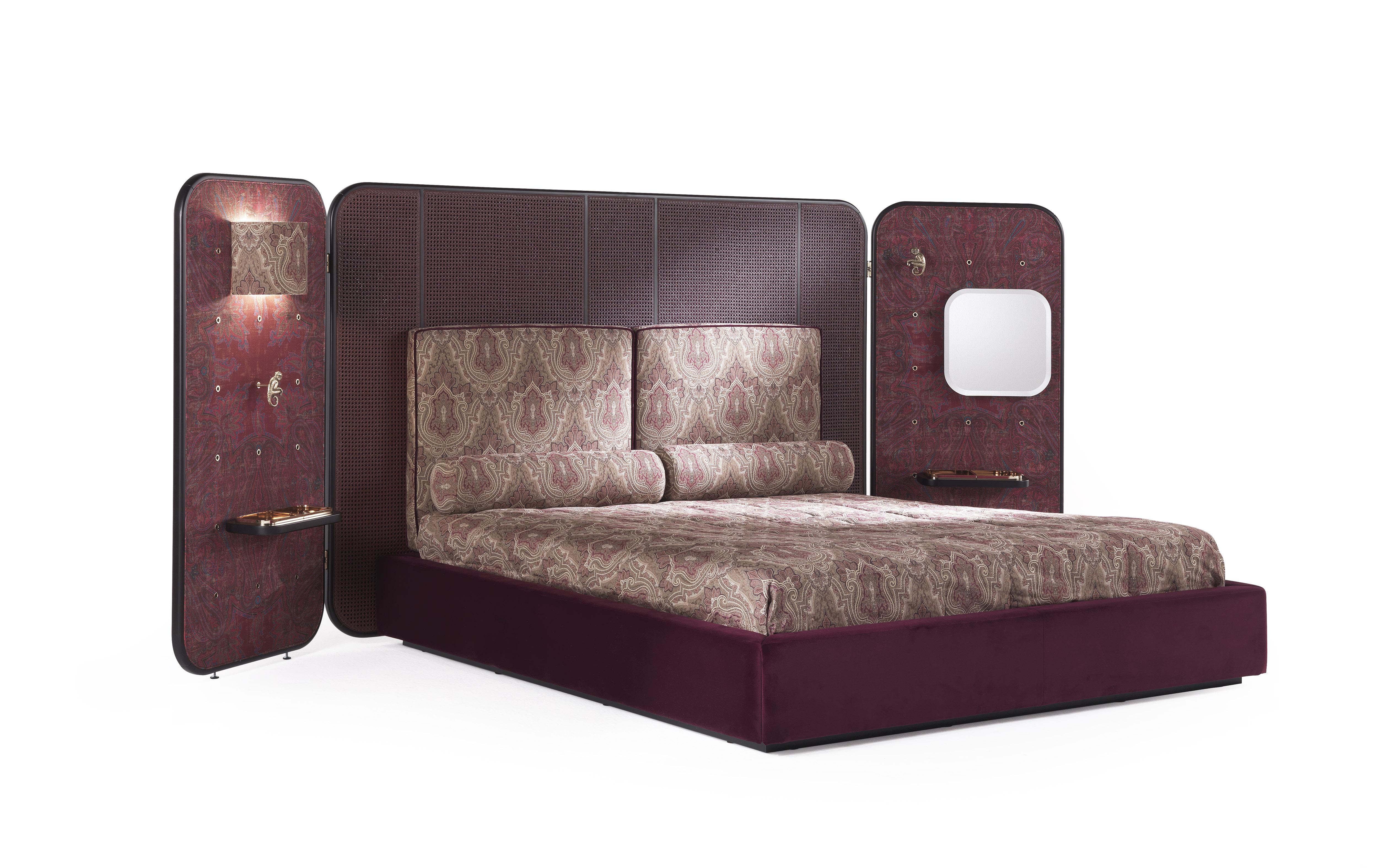An imposing bed that epitomizes the powerful and eclectic style of Etro Home Interiors collection. The impressive headboard in dark wengé dyed wood and cherry red lacquered cane is completed with two lateral panels upholstered with the evocative