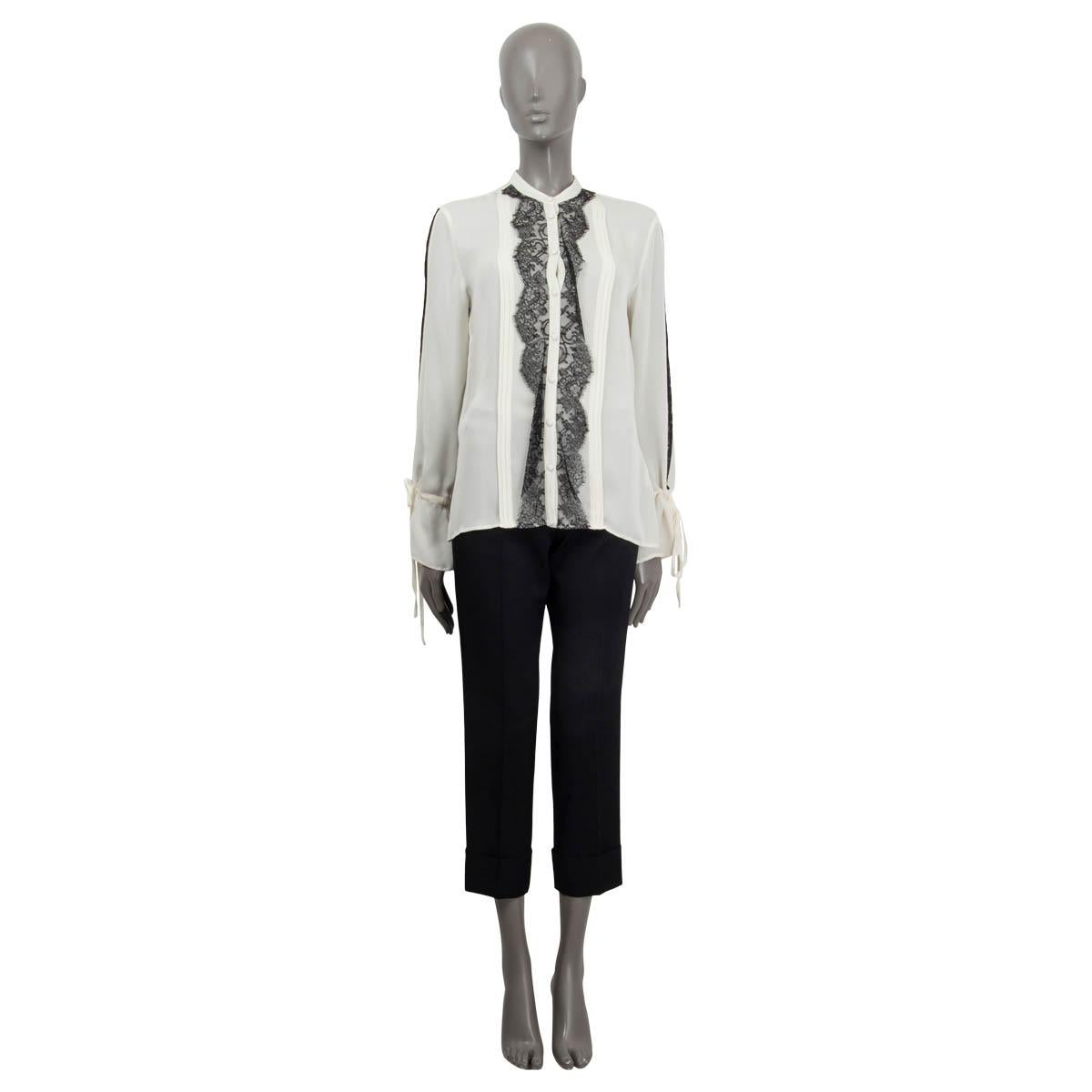 100% authentic Etro lace embellished pleated long sleeve blouse in semi-sheer white and black silk (100%). Features long sleeves and a drawstring closure at the cuffs. Opens with eight buttons on the front. Unlined. Has barely visible stains at the