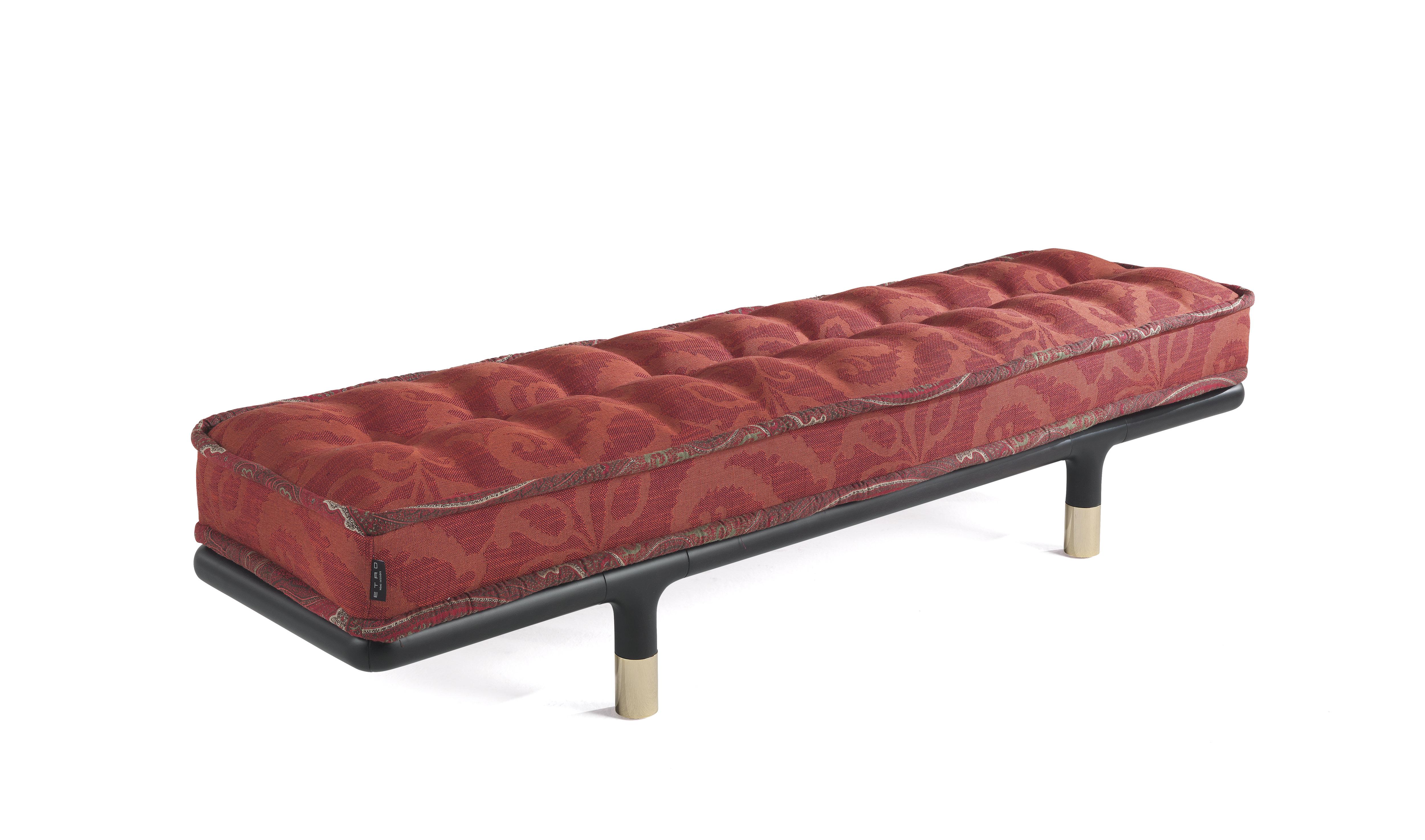 WOODSTOCK Bench with Structure in matte dark wengé dyed wood with tips in polished brass. Seat upholstered in fabric cat. B Greyton col. 4 Red with piping in fabric cat. A Deccan col. 1 Nomad.