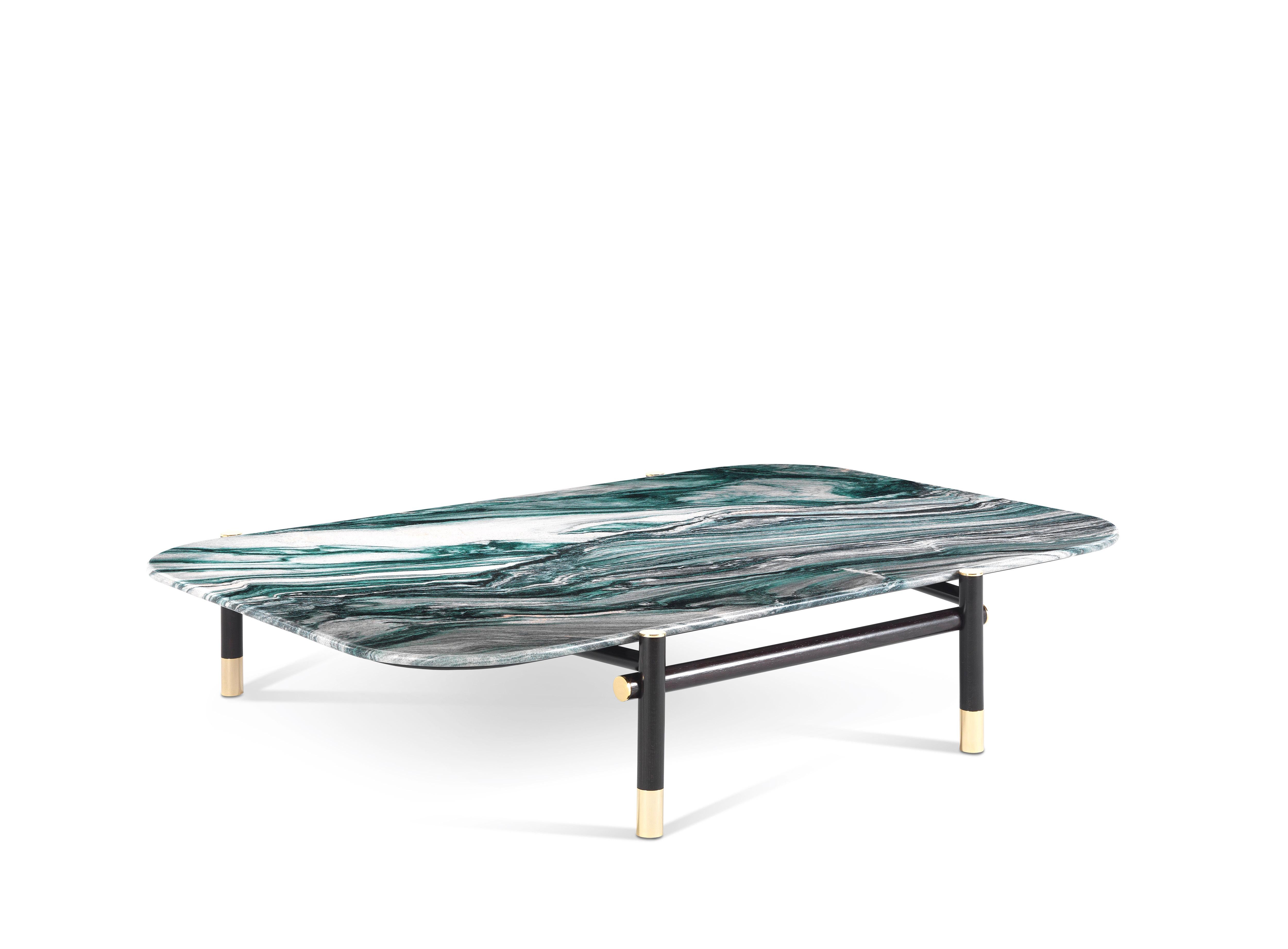 A central table with a precious appeal, featuring a special top in precious marble enhanced by refined details such as the polished brass tips of the basement. The table is a perfect expression of the extraordinary craftsmanship that characterizes