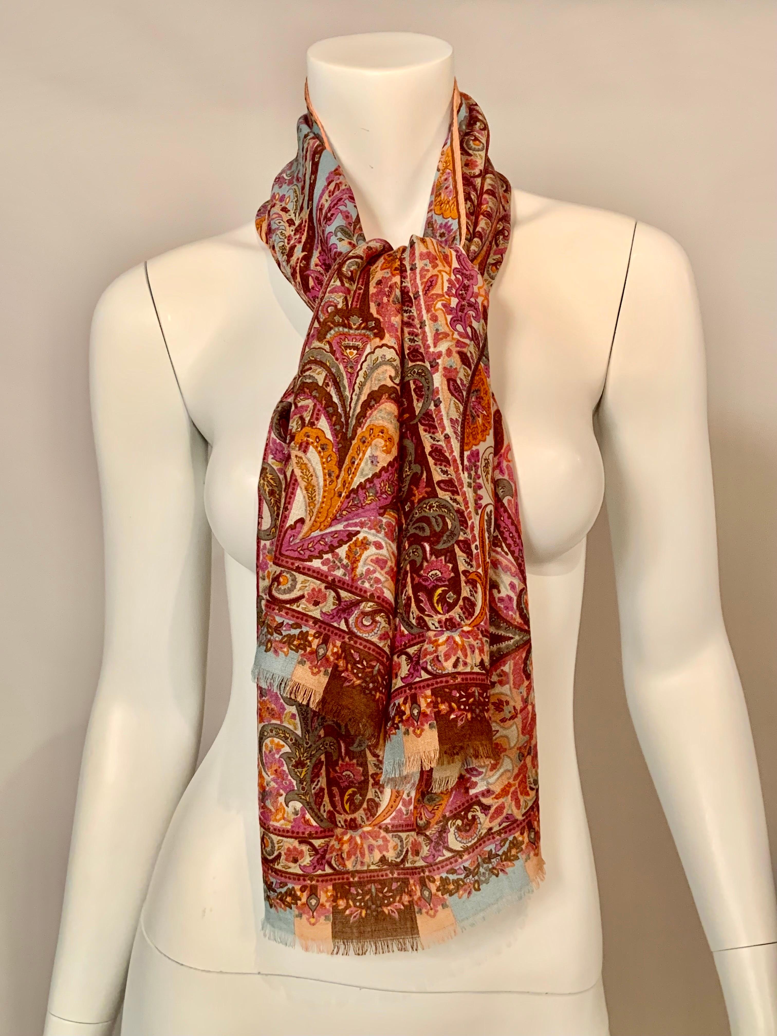 This light weight, sheer Etro scarf is made in the most beautiful Spring colors.  The center ground is blue and the paisley pattern is violet, pink, rose, orange, coral, medium green and pale green.  it is signed ETRO in one corner of the design and