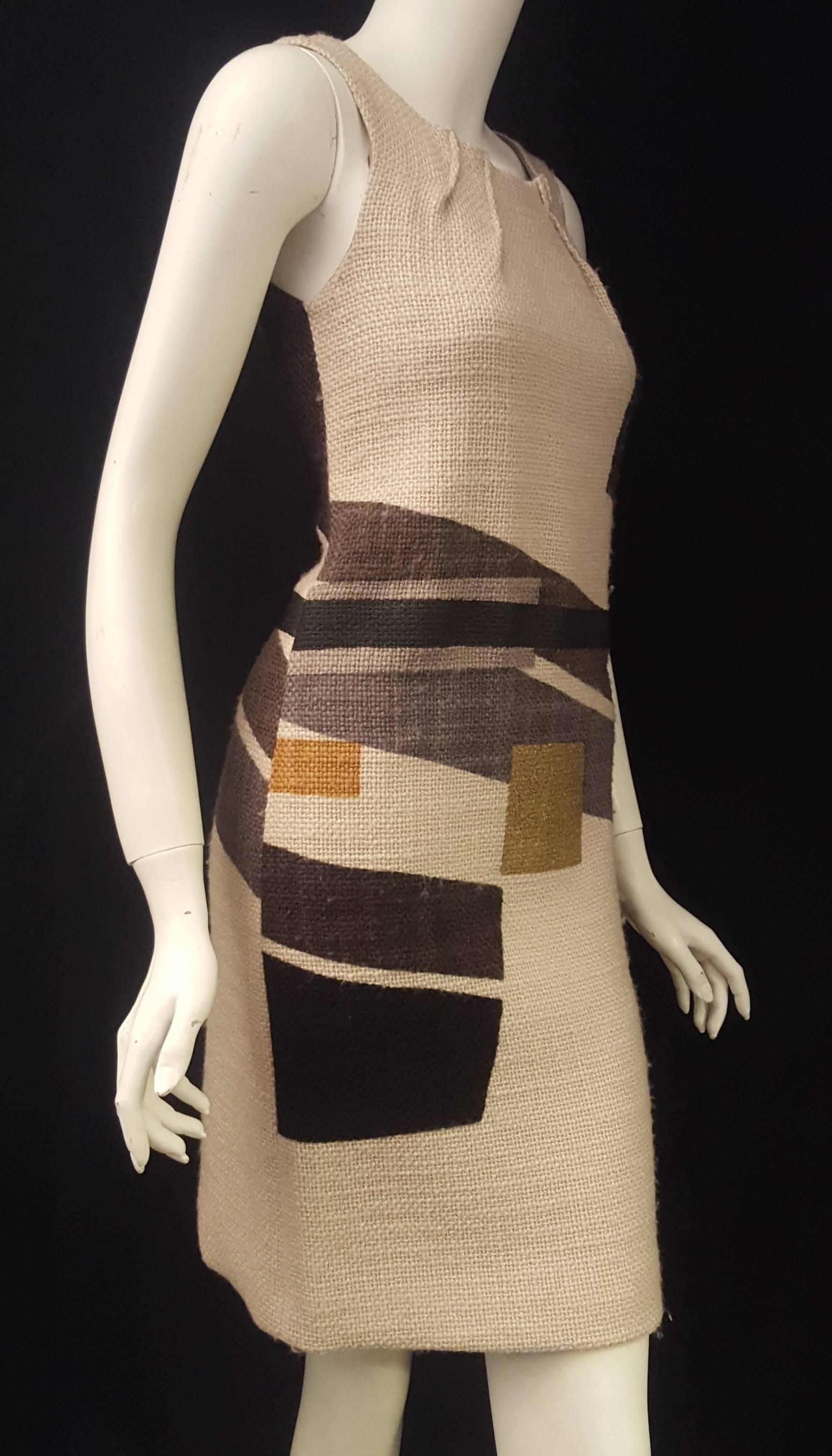 Etro geometric print wool sleeveless sheath dress is modern and trendy for today's women on the go.  The scoop neckline is highlighted with with 2 open darts at each side on the collar bone. This dress is multi color with base in tan and geo blocks