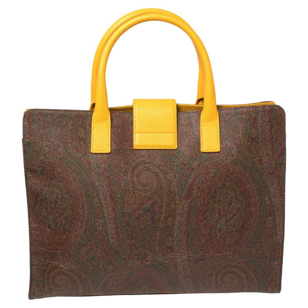 Make an exquisite appearance every time you carry this tote by Etro. it has been crafted from quality coated canvas and leather. It comes in lovely hues of brown & yellow and flaunts a paisley print throughout. It has dual handles and gold-tone