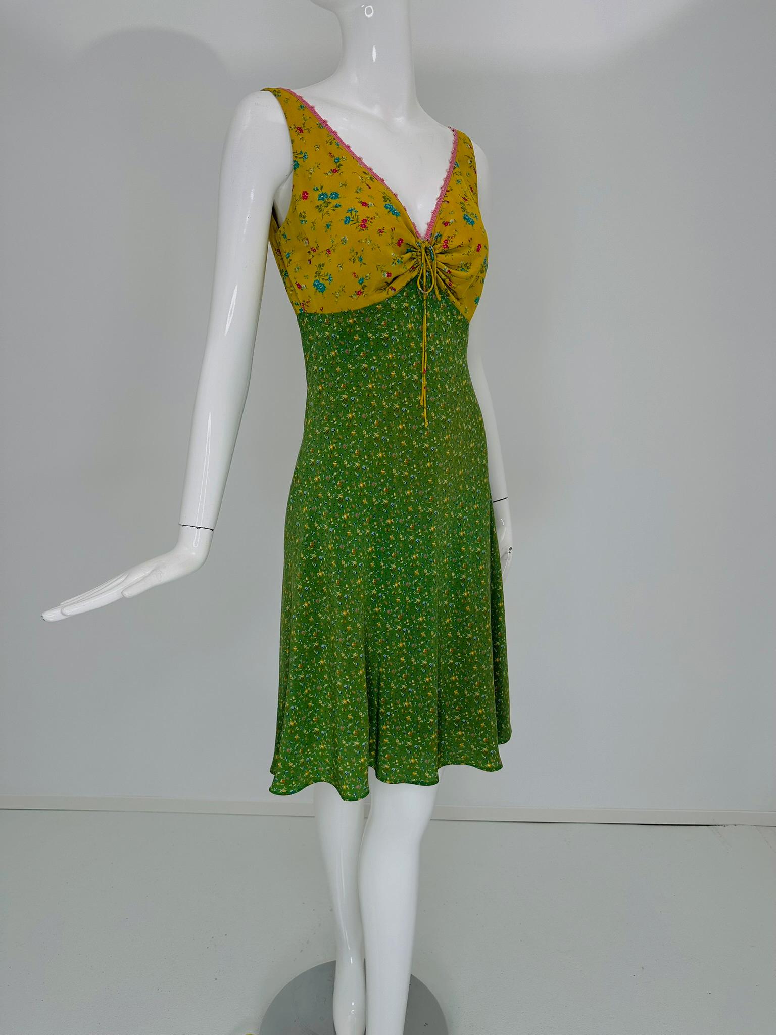 Etro summer dress with a V neckline and a cord tie keyhole front, it is trimmed with pink crochet and crystal beads. The bodice is sleeveless on a yellow/gold ground with scattered bouquets of mini flowers. Empire waist, the bias cut skirt has a