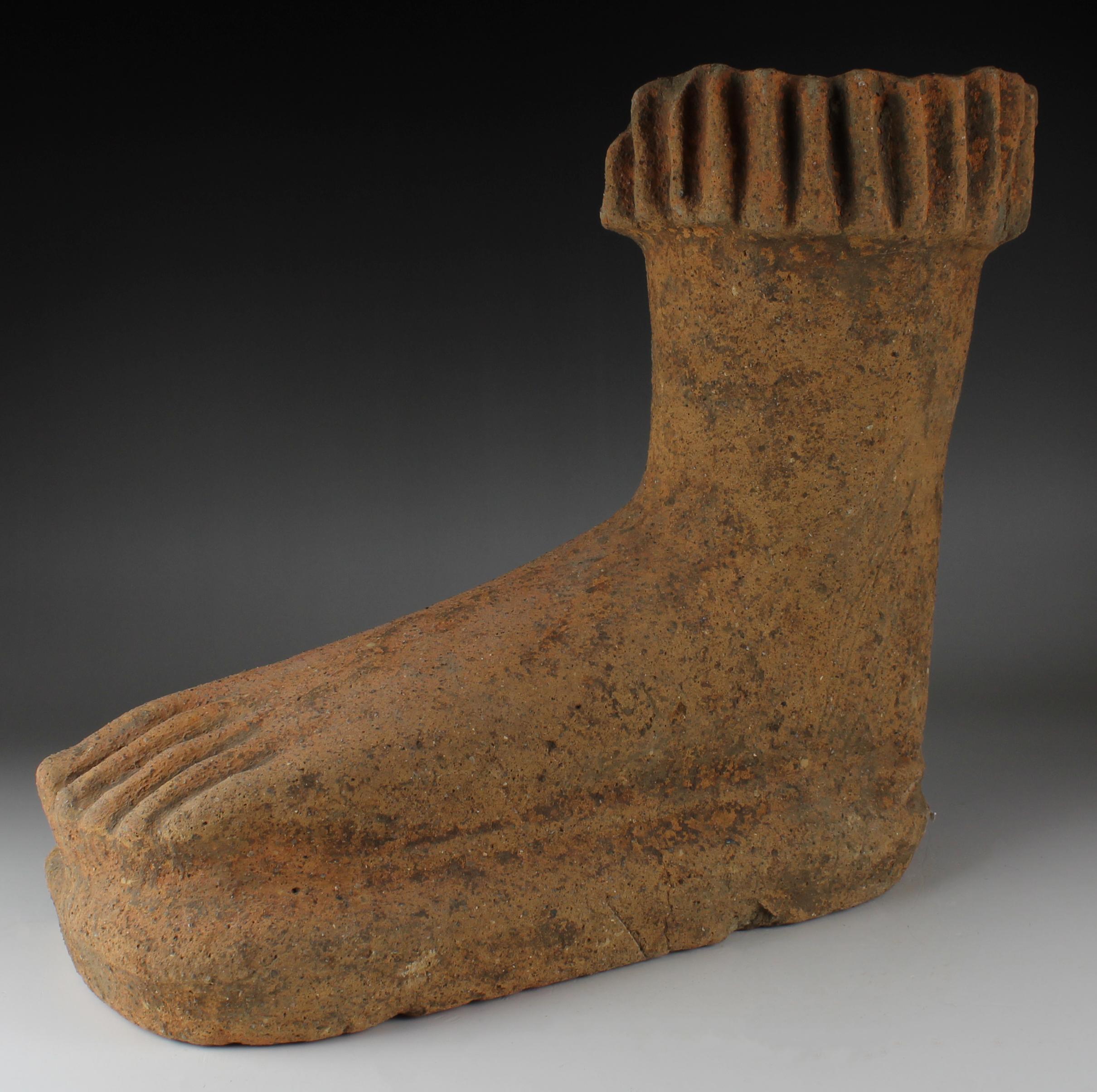 ITEM: Anatomical votive model of a foot
MATERIAL: Terracotta
CULTURE: Etruscan
PERIOD: 5th – 4th Century B.C
DIMENSIONS: 270 mm x 315 mm x 135 mm
CONDITION: Good condition
PROVENANCE: Ex American private collection, Maryland. Ex Black Cat