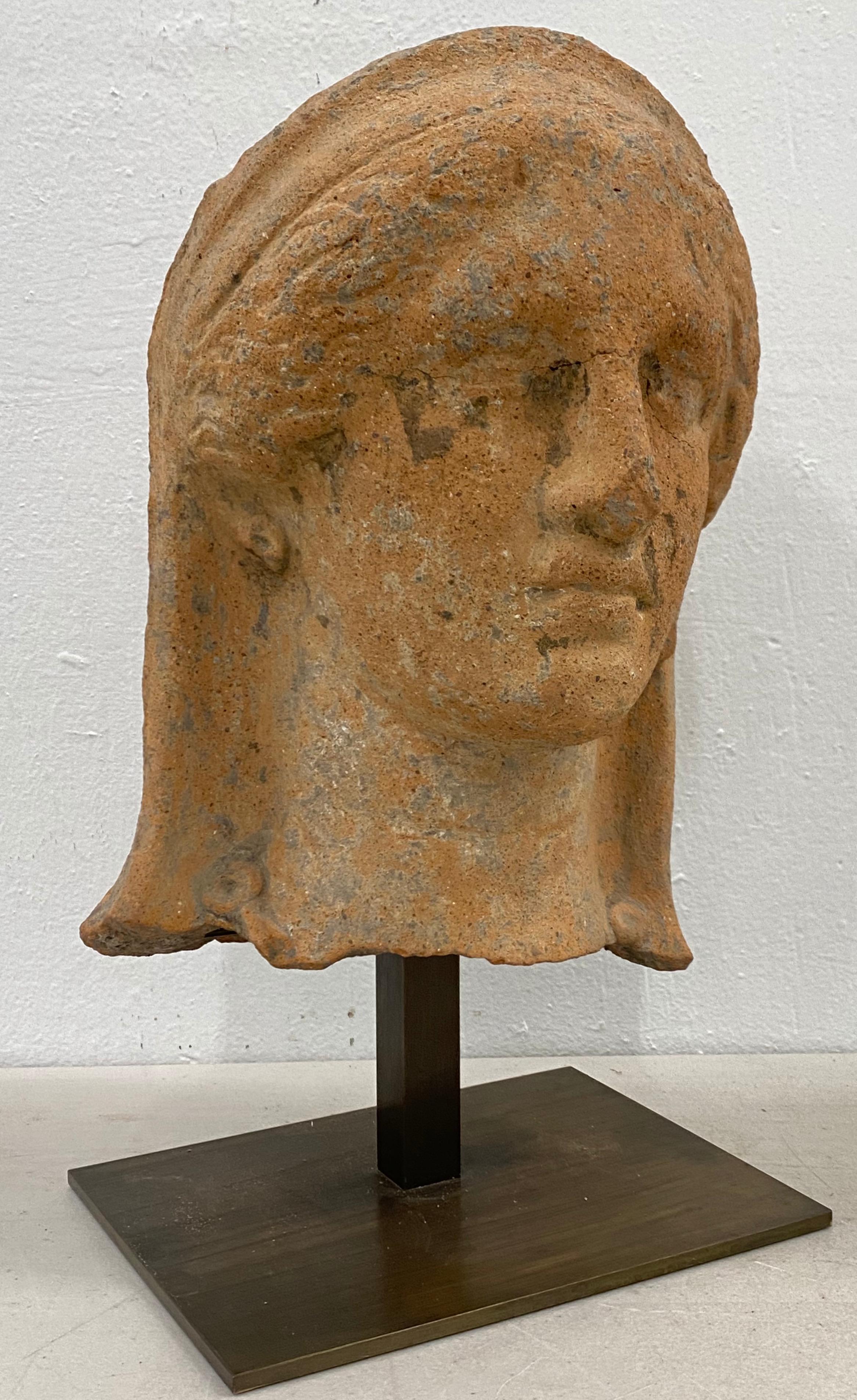 Etruscan antiquity terracotta head with stand

The terracotta measures 9