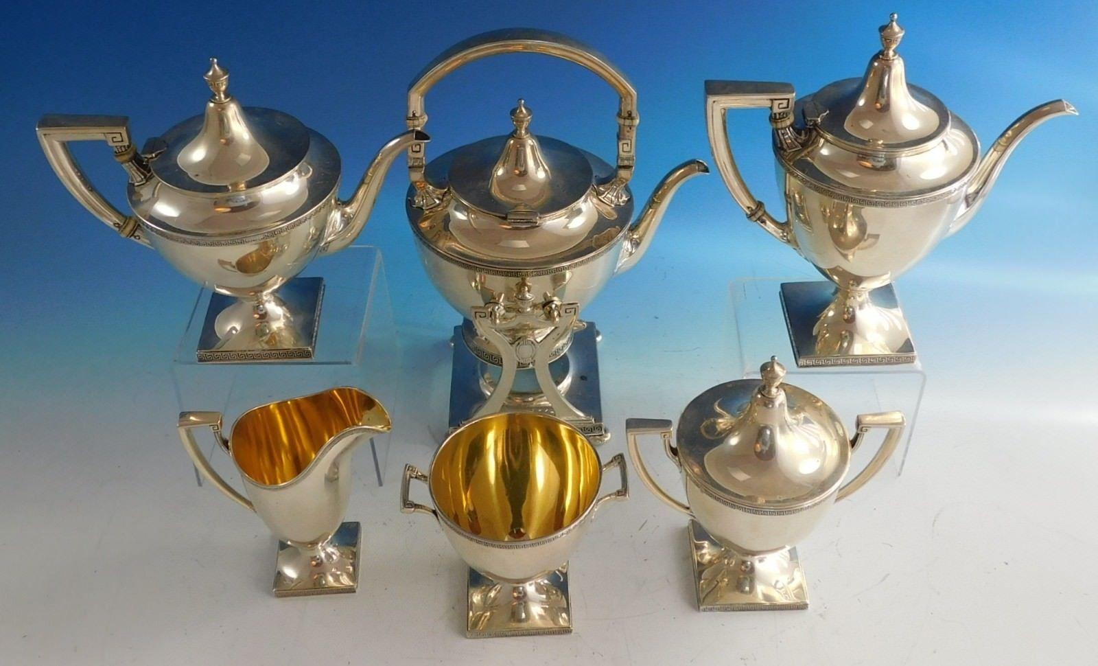 Etruscan by Gorham sterling silver 6-piece tea set with date marks for 1923. The set includes:  
1 - Impressive kettle on stand: Marked with #A9806, it weighs 42.11 ozt., and measures 12