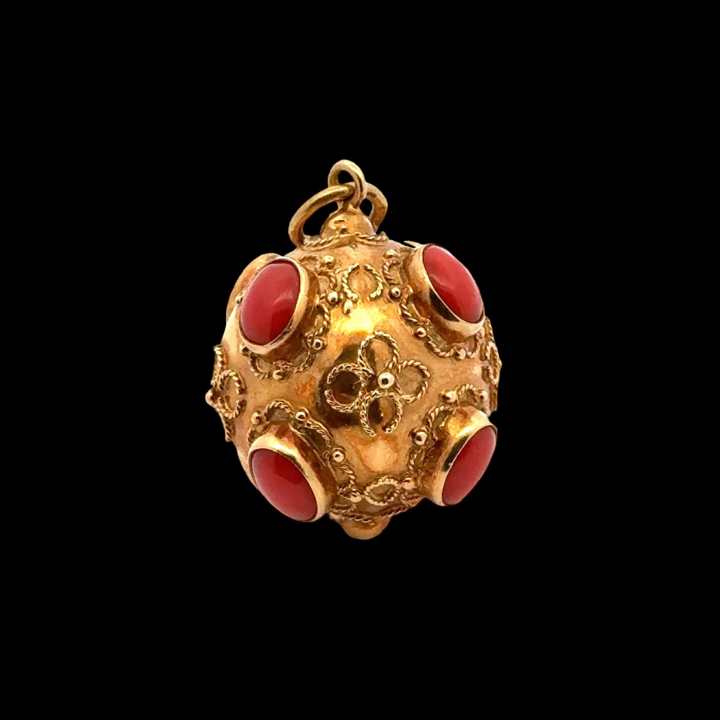 Beautiful Mid-20th Century Etruscan charm handcrafted in lustrous 18 karat yellow gold. The fob charm is accented with cabochon coral gemstones and the gold is enhanced wtih decoration and gold ribbon accents. The charm measures approximately an