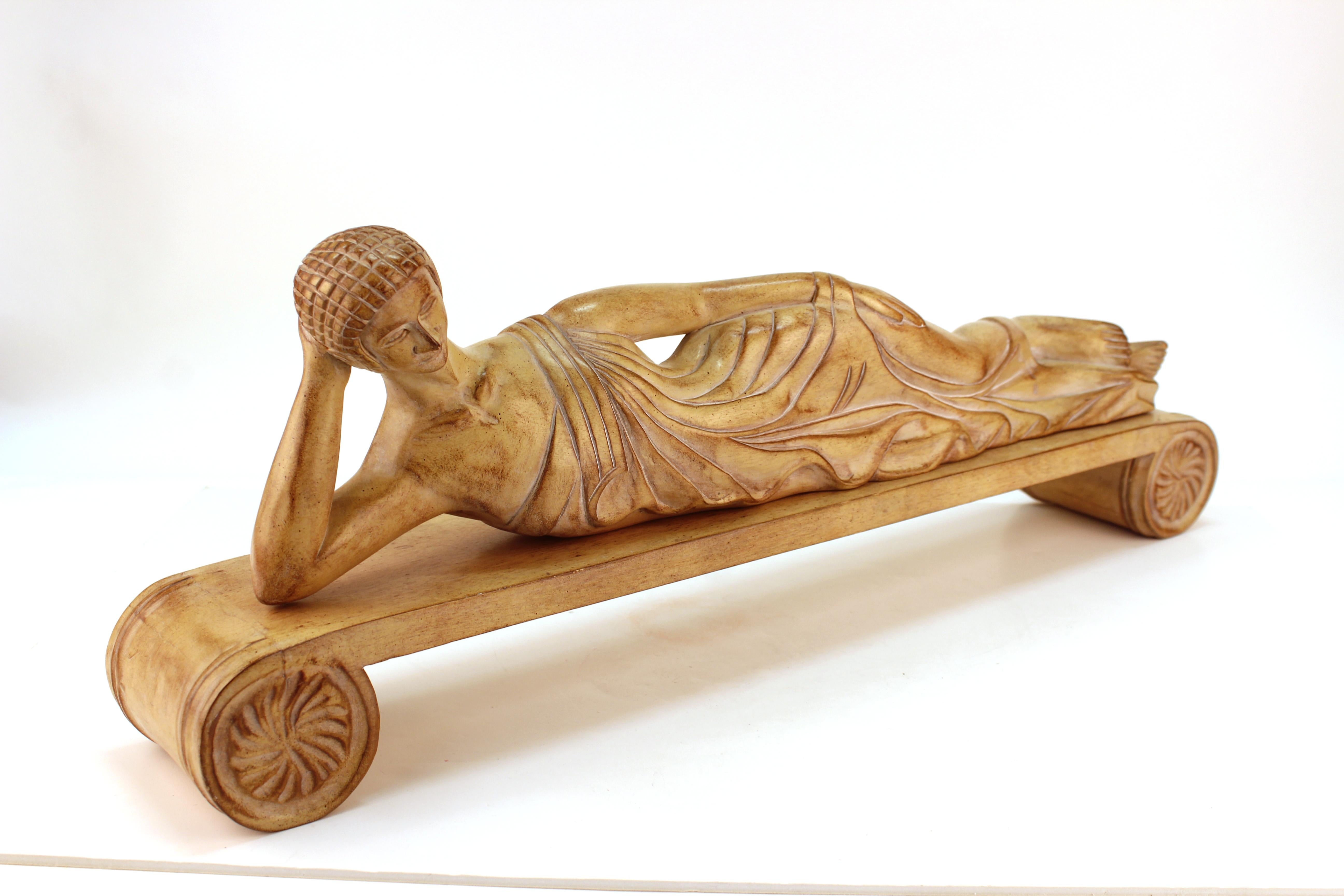 Etruscan style wood sculpture depicting a reclining woman on a scroll bench. In good vintage condition.
