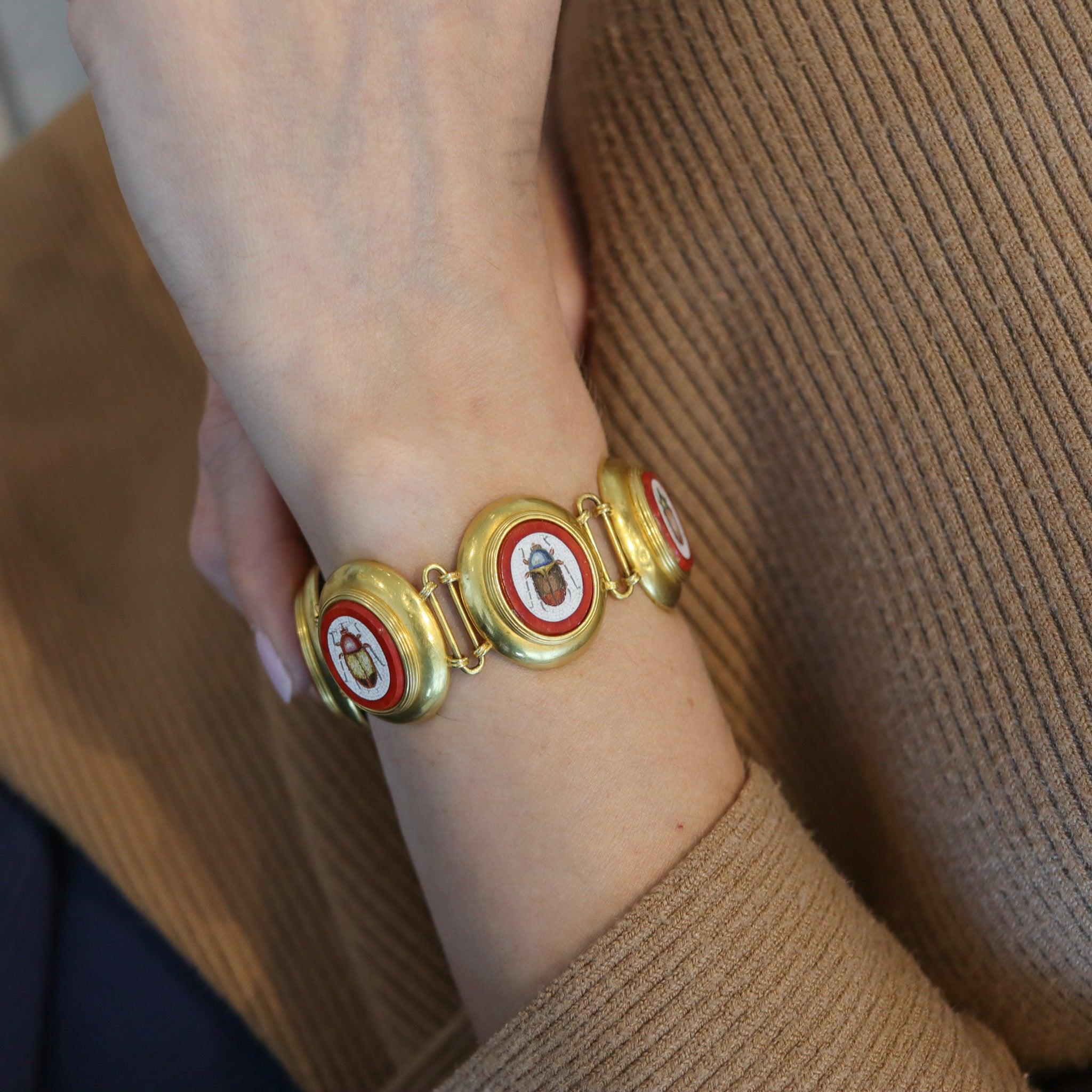 Etruscan revival grand tour bracelet with six scarabs

This is a beautiful and very rare historical bracelet depicting six different colorful scarabs, created during the Grand Tour era at the Papal States workshops in Rome Italy, back in the 1850.