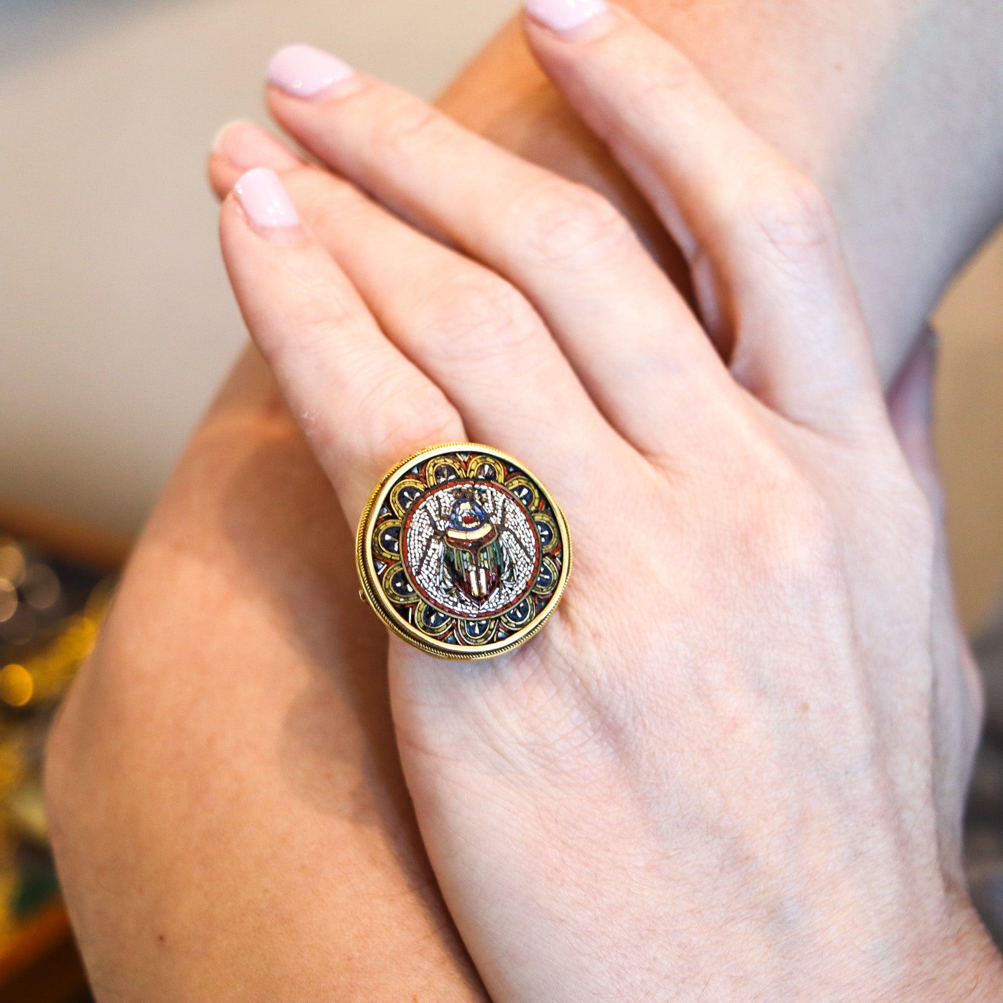 An Etruscan revival scarab ring.

This is an exceptional ring, created in Rome Italy during the Victorian (1840-1901) era, back in the 1880. The ring was masterfully crafted with Etruscan revival patterns in solid rich yellow gold of 18 and 15