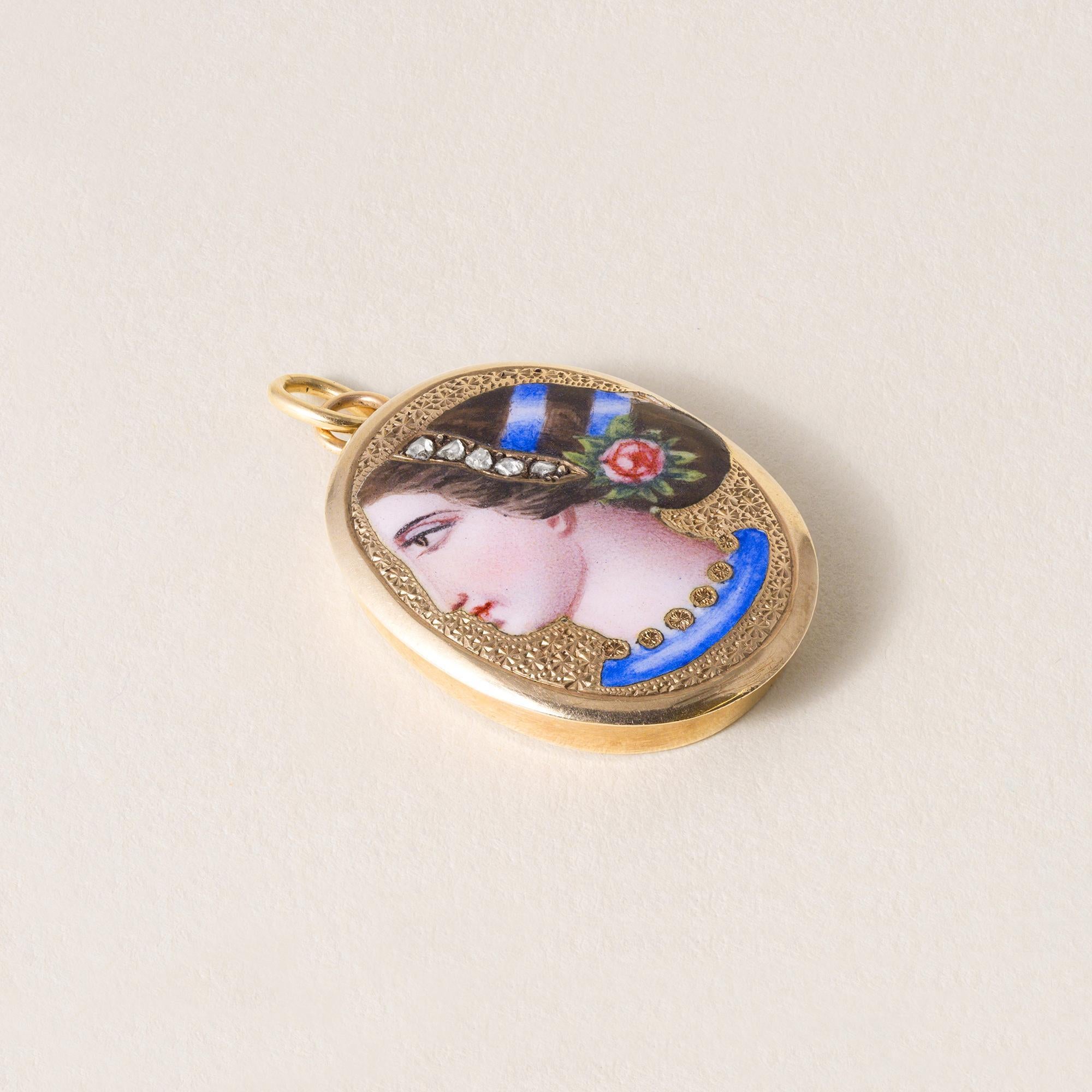 This is an antique pendant featuring an Etruscan revival portrait
of a woman in a traditional headdress with rose cut diamonds.
Circa 1870
5 rose cut diamonds weigh ~ 0.05 carats
4.94 grams
18K gold
Minor enamel damage on the outer headdress
(please