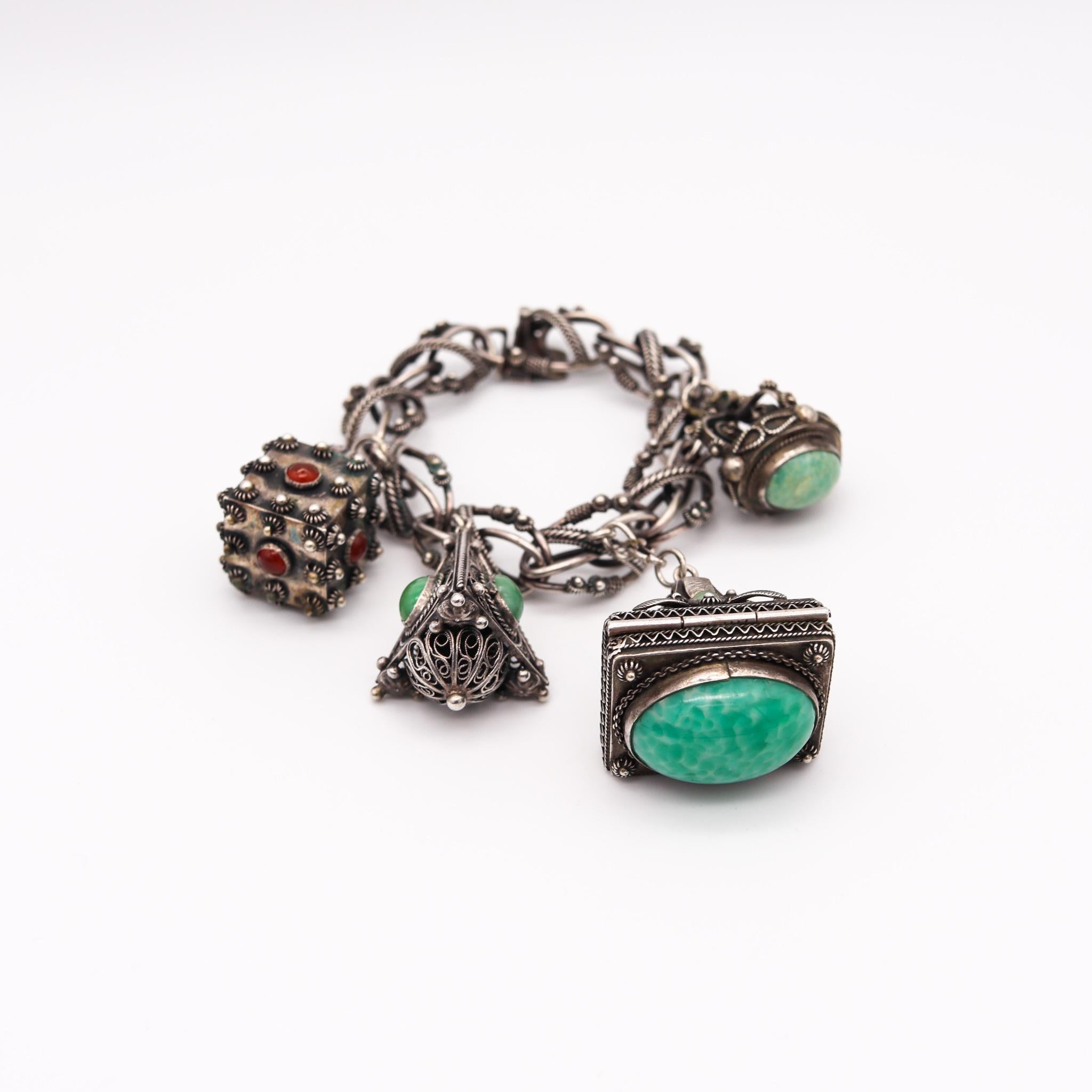An Etruscan revival gypsy charms bracelet.

An oversized charms bracelet made in Italy, back in the 1930. This gypsy bracelet has been crafted with Etruscan revival patterns in solid .800/.999 silver with highly textured elements. Fitted with a