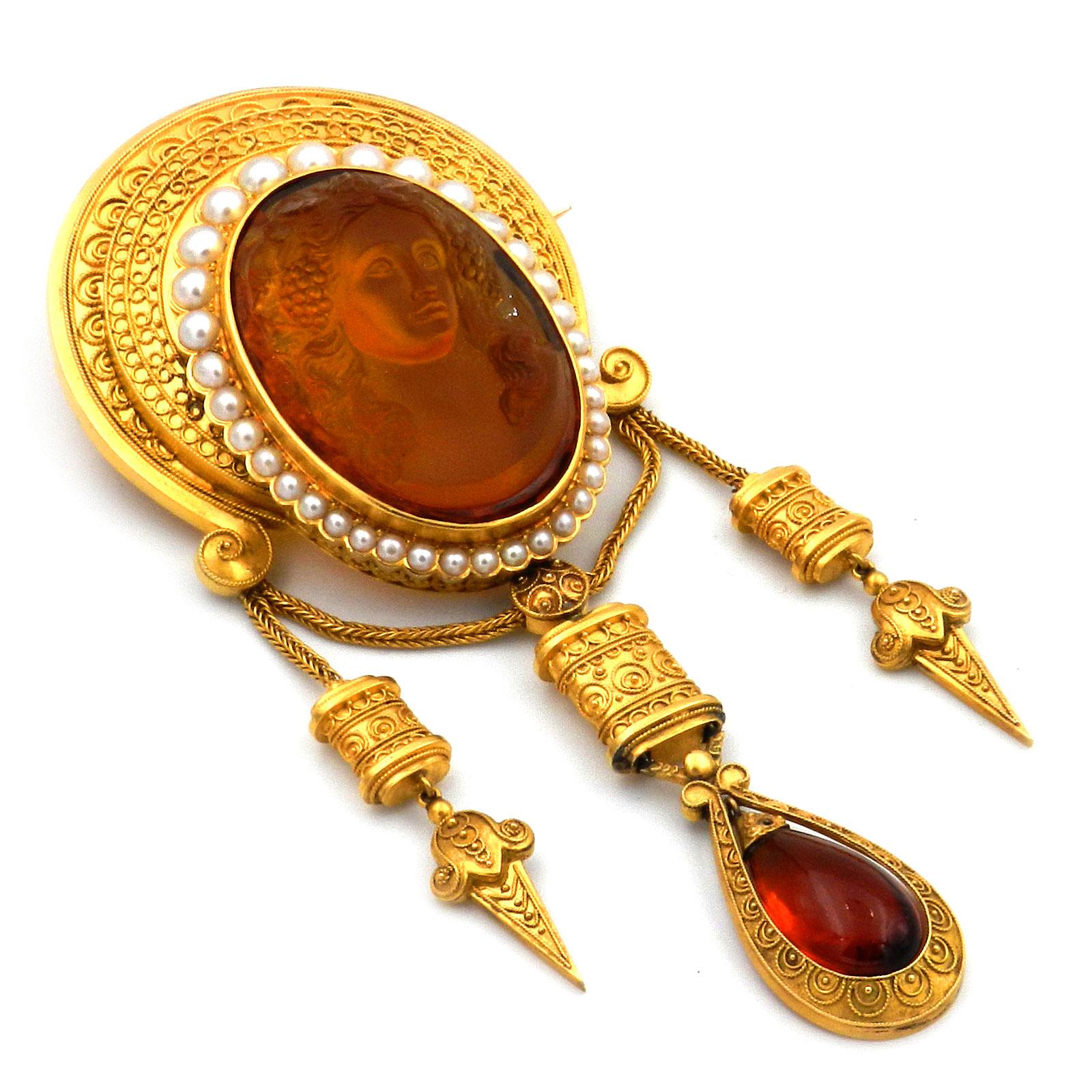 Etruscan Revival Citrine Cameo and Pearl Gold Brooch, France circa 1870

Important brooch in the archaeological style, set with a golden yellow, detailed cut citrine cameo depicting the goddess Flora and framed by a row of oriental pearls, mounted