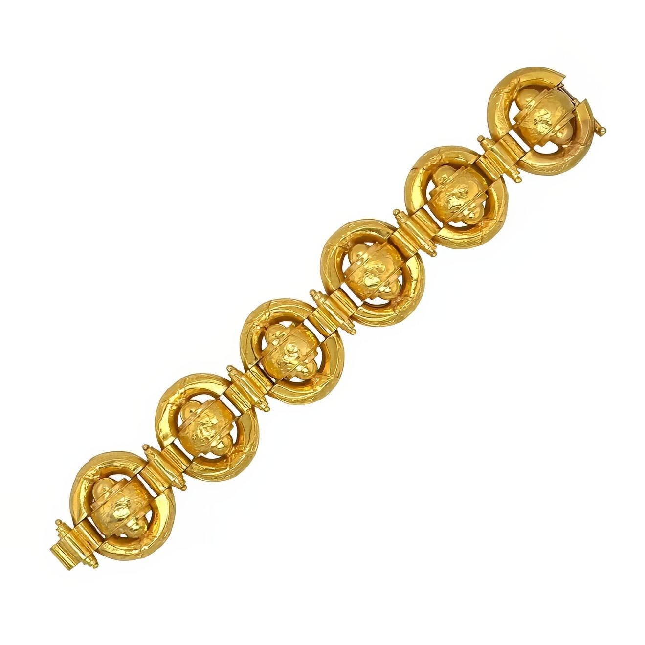 A 21 karat yellow gold bracelet.  The Etruscan Revival style bracelet displaying large oval links enclosing stylized urn forms all decorated with floral and foliate motifs, the ovals connected by bracket links enhanced with ropework detail.  Length