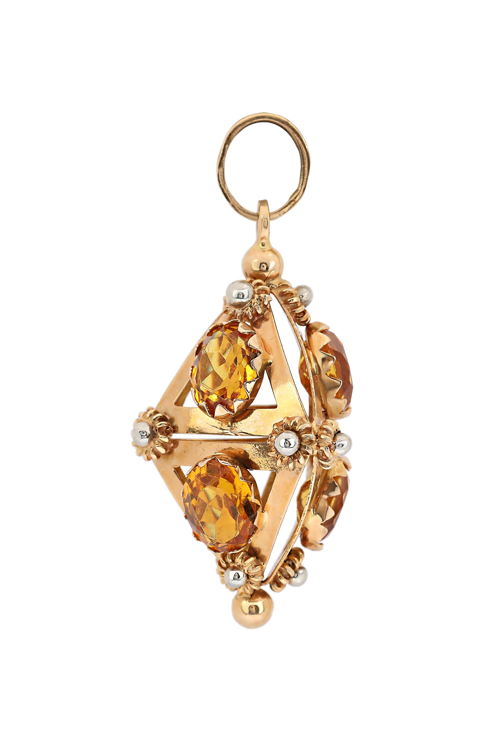 An 18 karat yellow gold charm fob pendant designed as an Etruscan pendant embellished by six oval shaped Citrine. The stones have vivid orangey-yellow color and weigh about 9 carats. The pendant is decorated with beautiful two tone rosettes and bead