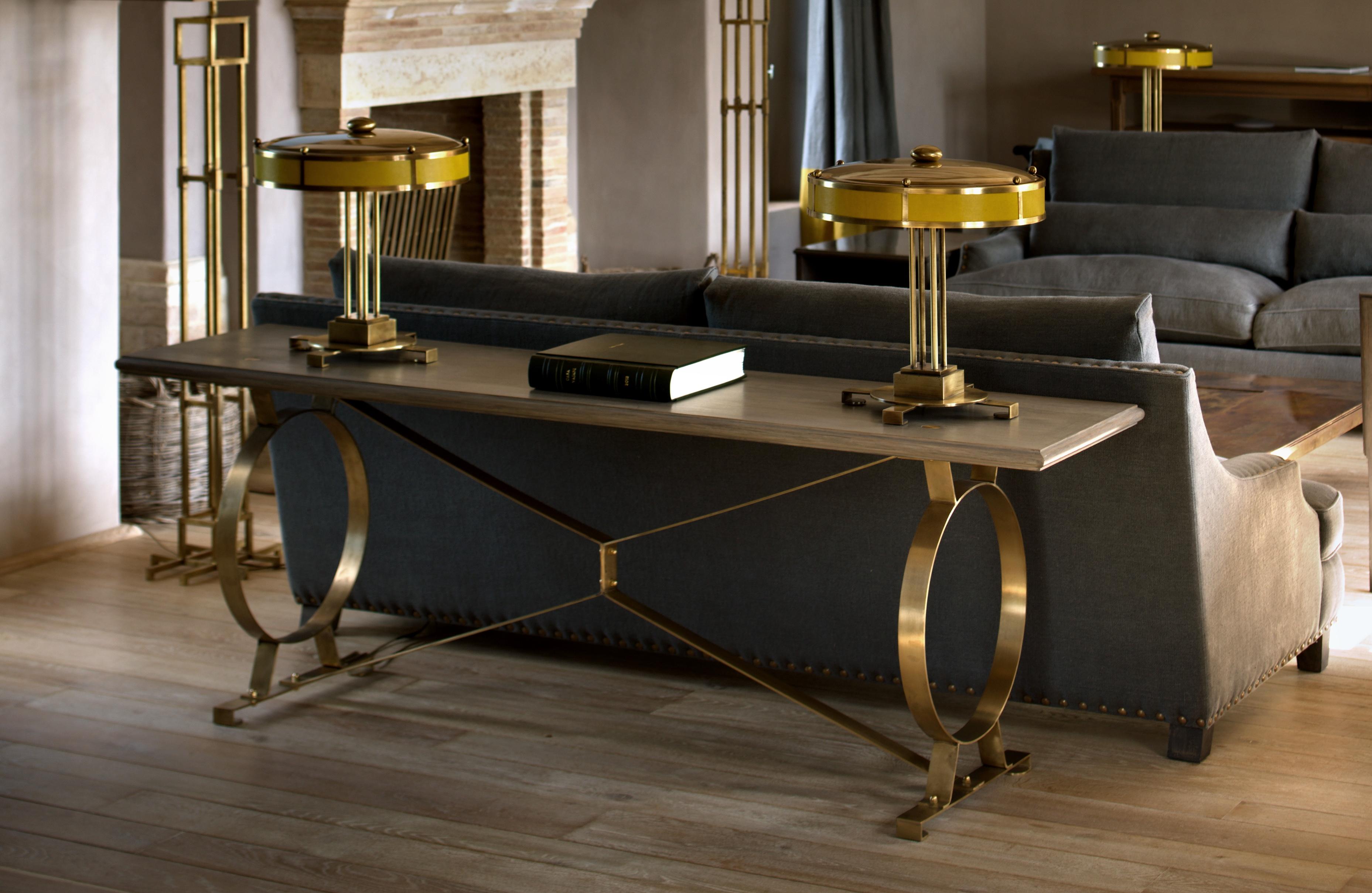 A grisaille oak and brass sofa table.

B.B. - Inspired by Etruscan designs, it can be used either behind a sofa or as a great object table against the wall. Its construction allows for a rather satisfying springiness. I love the rebated brass