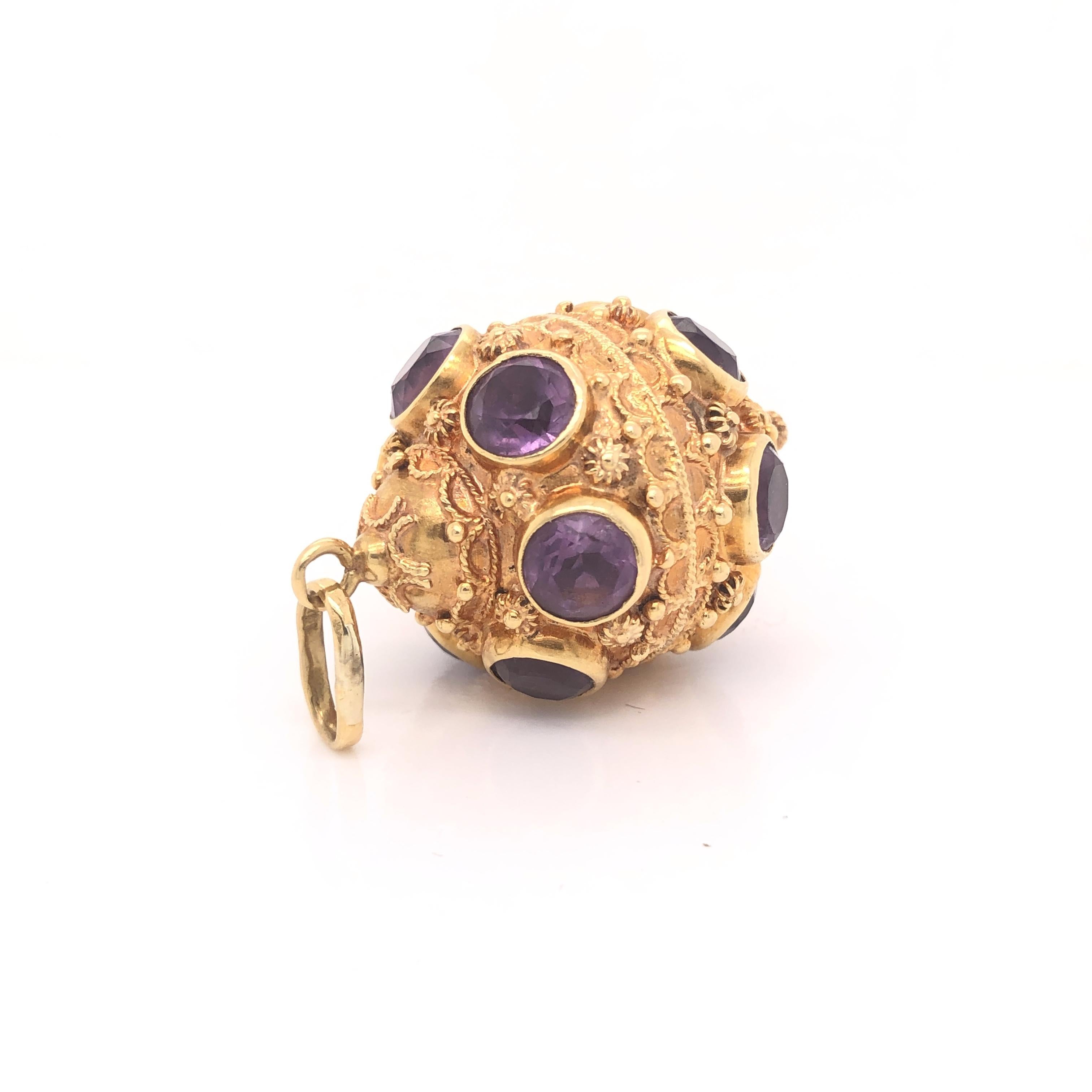 Amazing detail on this vintage treasure. The charm is crafted in 18k yellow gold with details seen throughout. The charm shows Etruscan period details and is set with Amethyst gemstones throughout. Each Amethyst gemstone weighs approximately .75 -