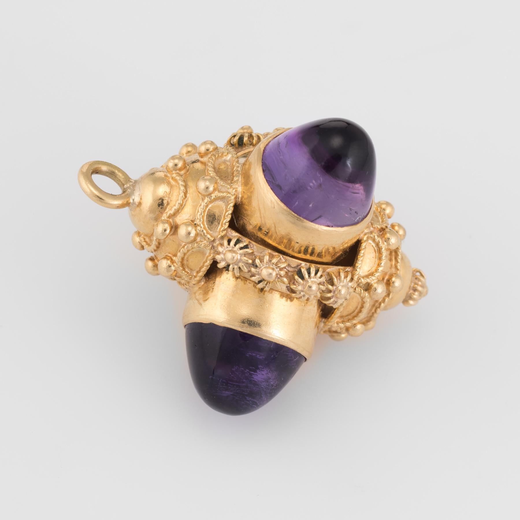 Finely detailed vintage Etruscan style pendant (or charm), crafted in 18 karat yellow gold.  

Three amethysts are cabochon cut measuring 8.5mm x 5mm. The amethysts are a deep royal purple color and in excellent condition (free of cracks or chips).