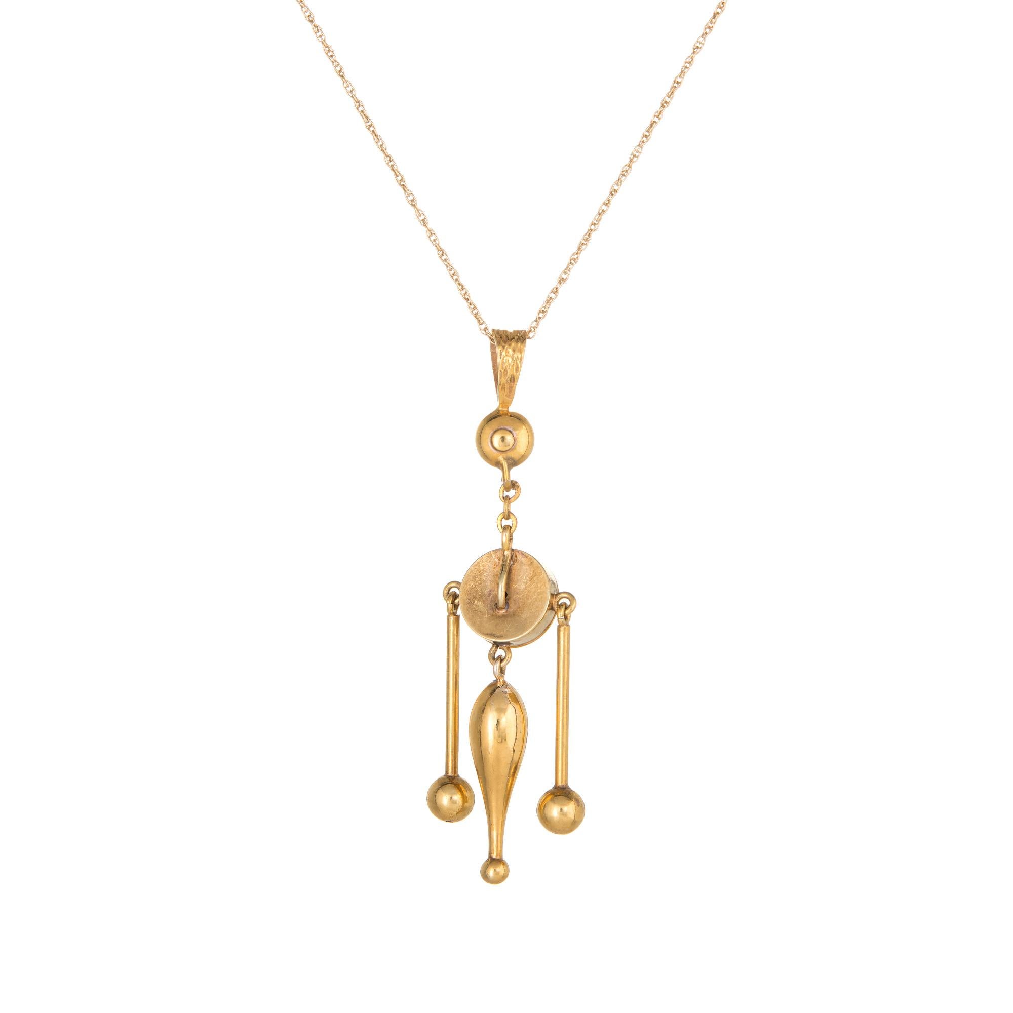 Stylish and finely detailed vintage Etruscan style drop pendant & necklace crafted in 14 karat yellow gold.  

The pendant features Etruscan style detailing to the round center with an attached three tier drops. The necklace is great worn alone or