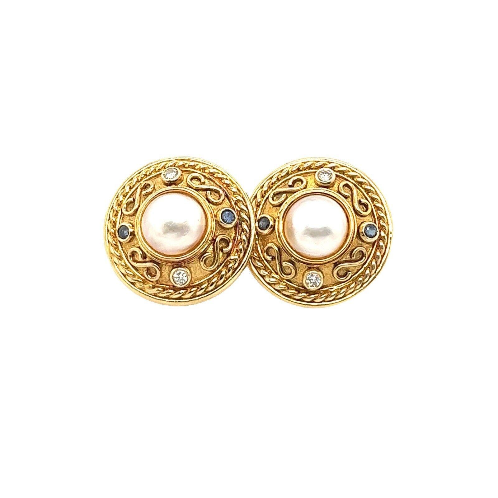 This pair of Etruscan style earrings features 2 round brilliant cut Diamonds & 2 Sapphire set in 9ct Yellow Gold in a round shape. It's perfect for every day and can be worn with any outfit.

Additional Information:
Total Diamond Weight: