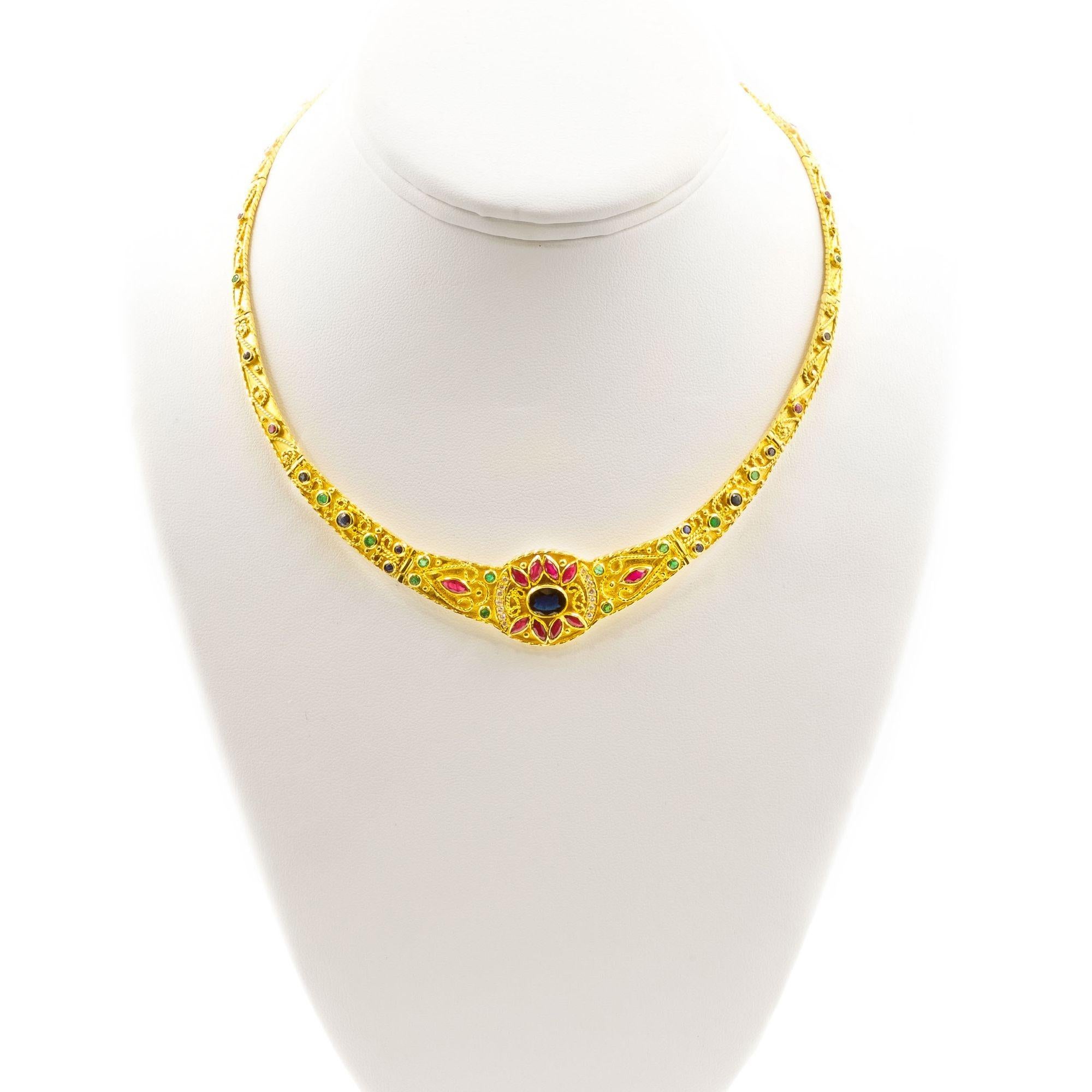 An absute eye-catcher, this intricately cast and beautifly detailed necklace is crafted of sid 18 karat yellow gd with a brilliant array of gemstones set within each individually cast and hinged link. These cminate in the stunning central focal