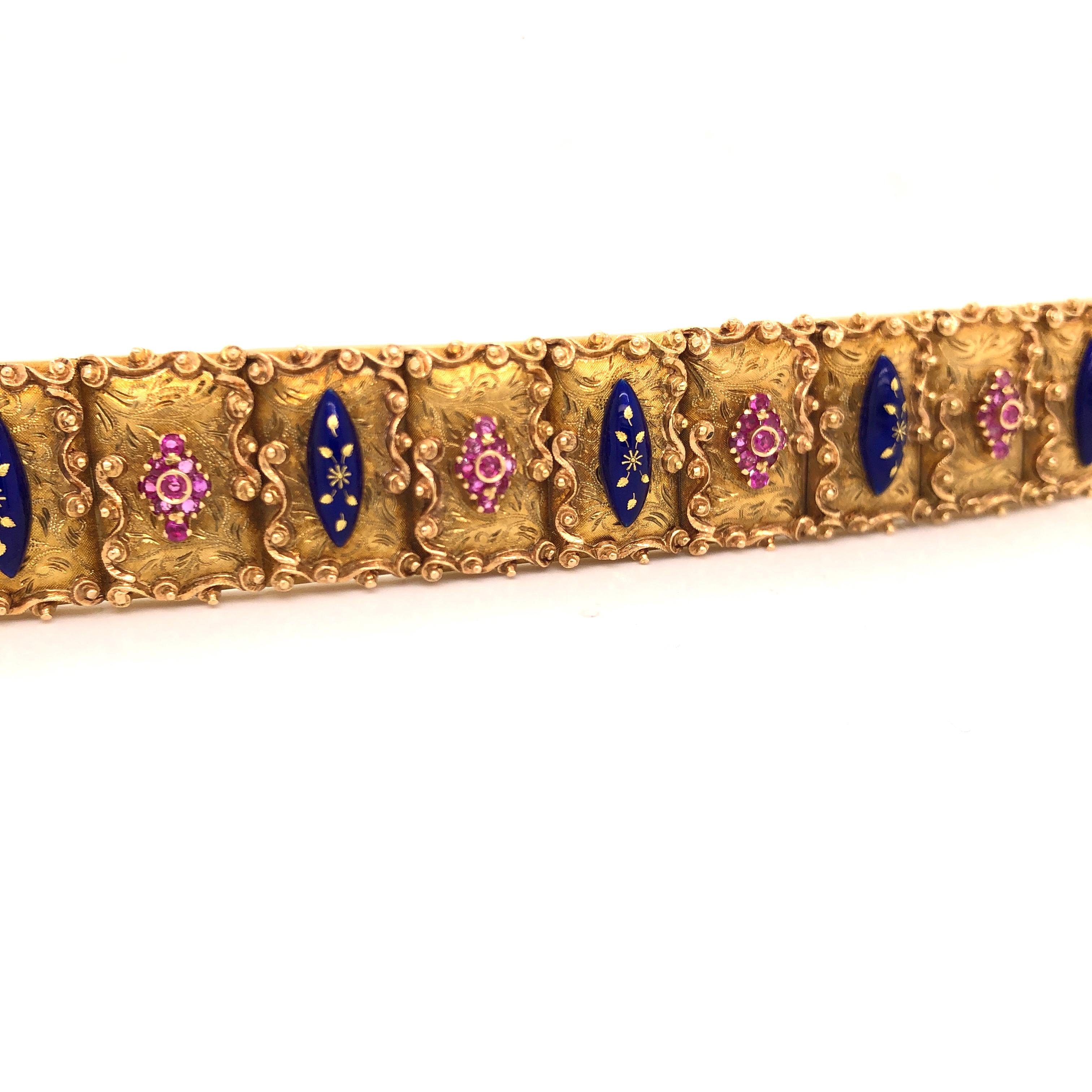 Equisite detail is seen in this beautiful 18k yellow gold bracelet. The bracelet weighs 73.5 grams and is hallmarked with Italian made stamps. This wide ladies bracelet is decorated with rubies and enamel giving a contrast of color that pops off