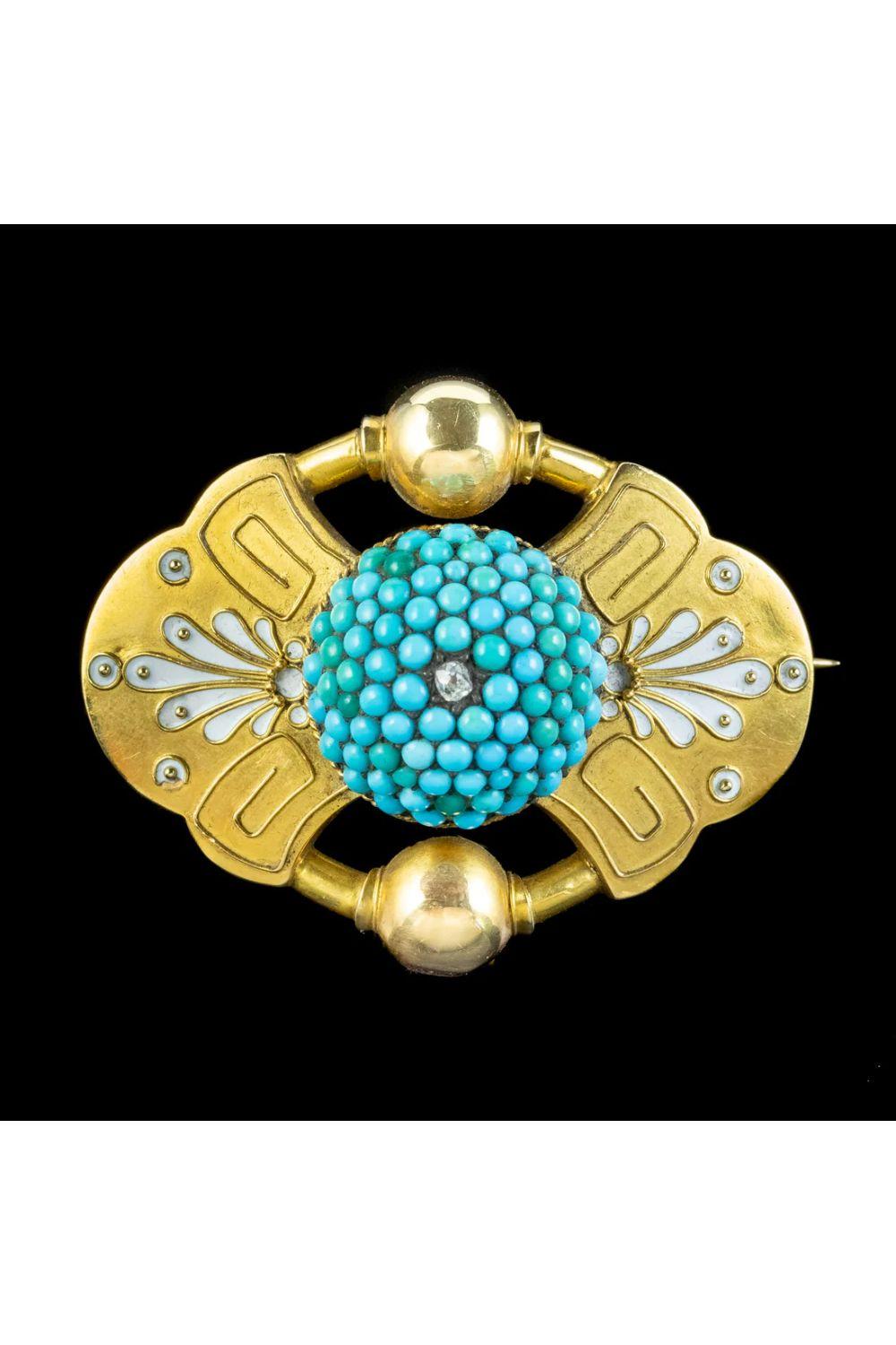 A remarkable antique Victorian Etruscan revival brooch fashioned in 18ct gold with a large turquoise encrusted dome in the centre, topped with a twinkling old mine cut diamond. 

Etruscan revival pieces were crafted in the late 1800s after ancient