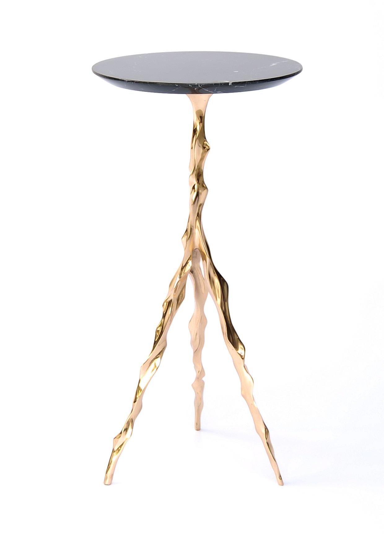 Etta drink table with nero marquina marble top by Fakasaka Design.
Dimensions: W 27 cm, D 27 cm, H 62 cm.
Materials: polished bronze base, Nero Marquina marble top.
 
Also available in different table top materials:
Nero Marquina Marble
