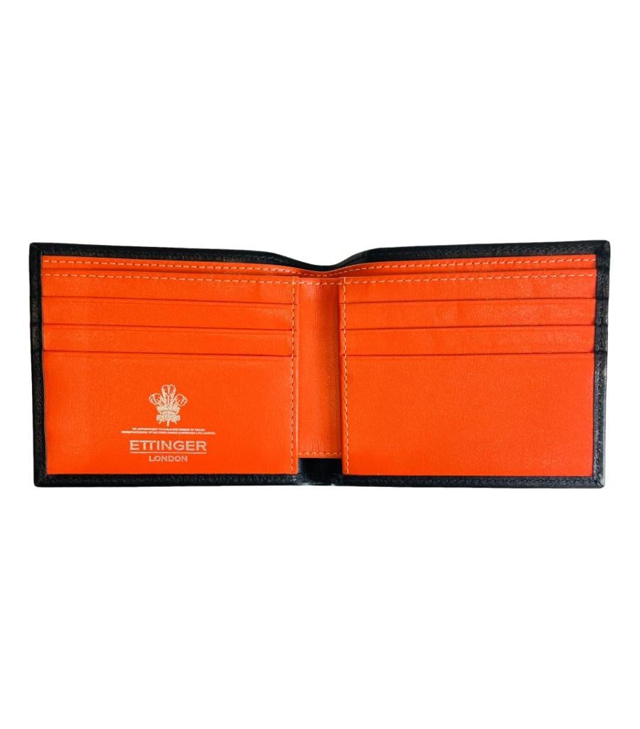 Ettinger Sterling Billfold Wallet
Black smooth leather wallet with bright orange interior.
Designed with white logo print to the inside and styled with six credit card slots and two slip pockets. Rrp £220
Size – 11cm x 9cm
Condition – Very Good