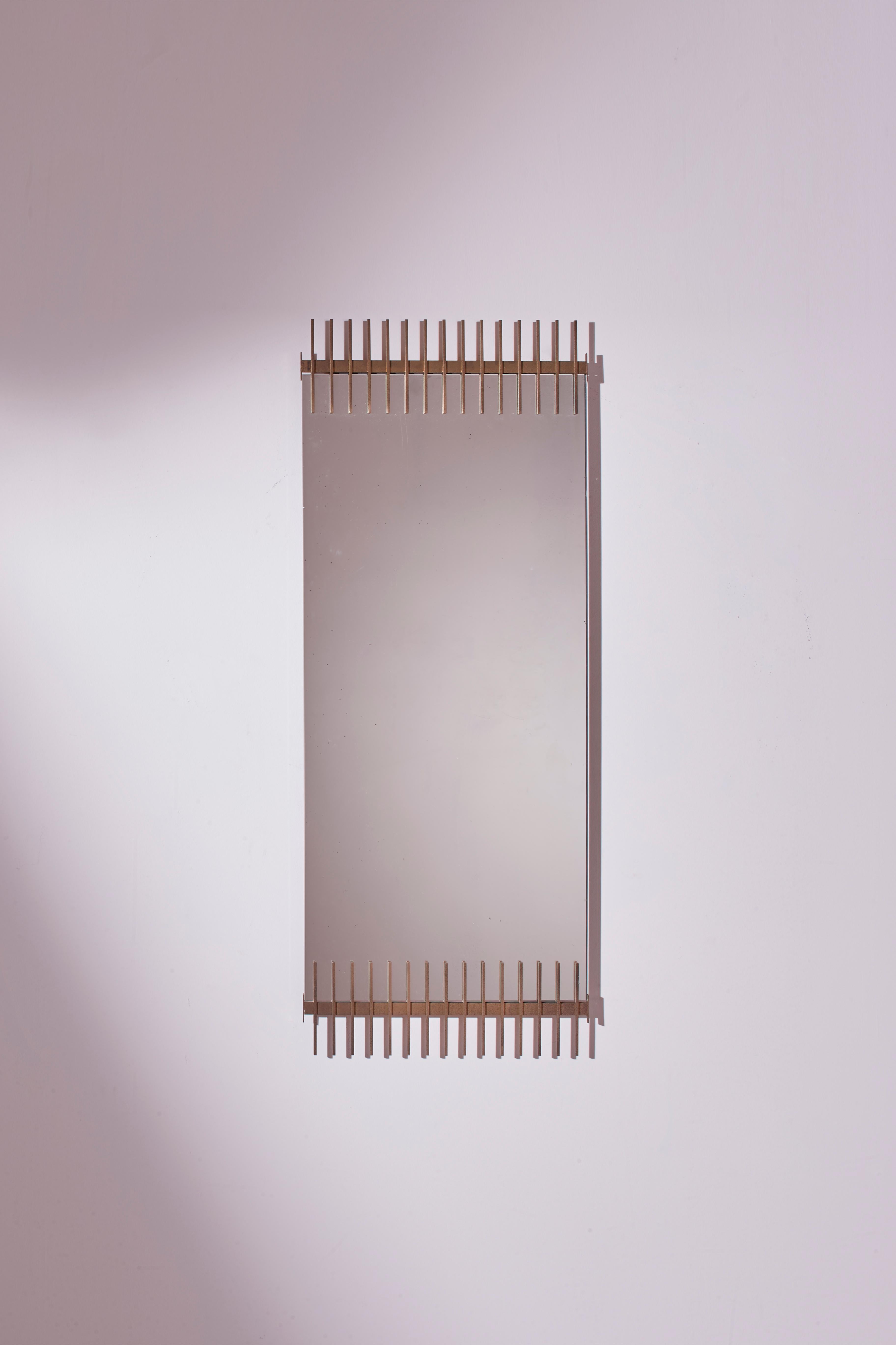 An elegant and original wall mirror, designed by Ettore Sottsass and produced by Santambrogio e De Berti in Lissone in the 1958.

Crafted with exquisite materials such as brass and glass resting on a black enameled metal structure at the back, this