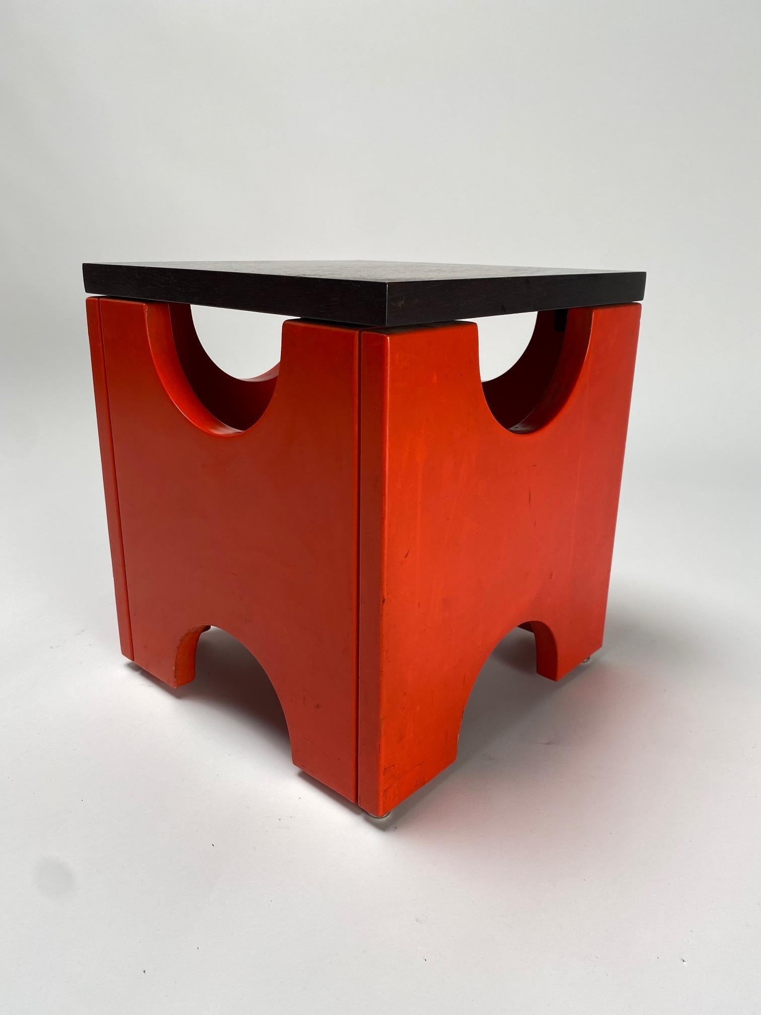 Ettore Sottsass, Dado T29 stool, Poltronova production, Italy, 1960s

  It is one of the most iconic works by the famous Italian architect and designer Ettore Sottsass. The wooden base is painted red, with a plain walnut top. Below there are four