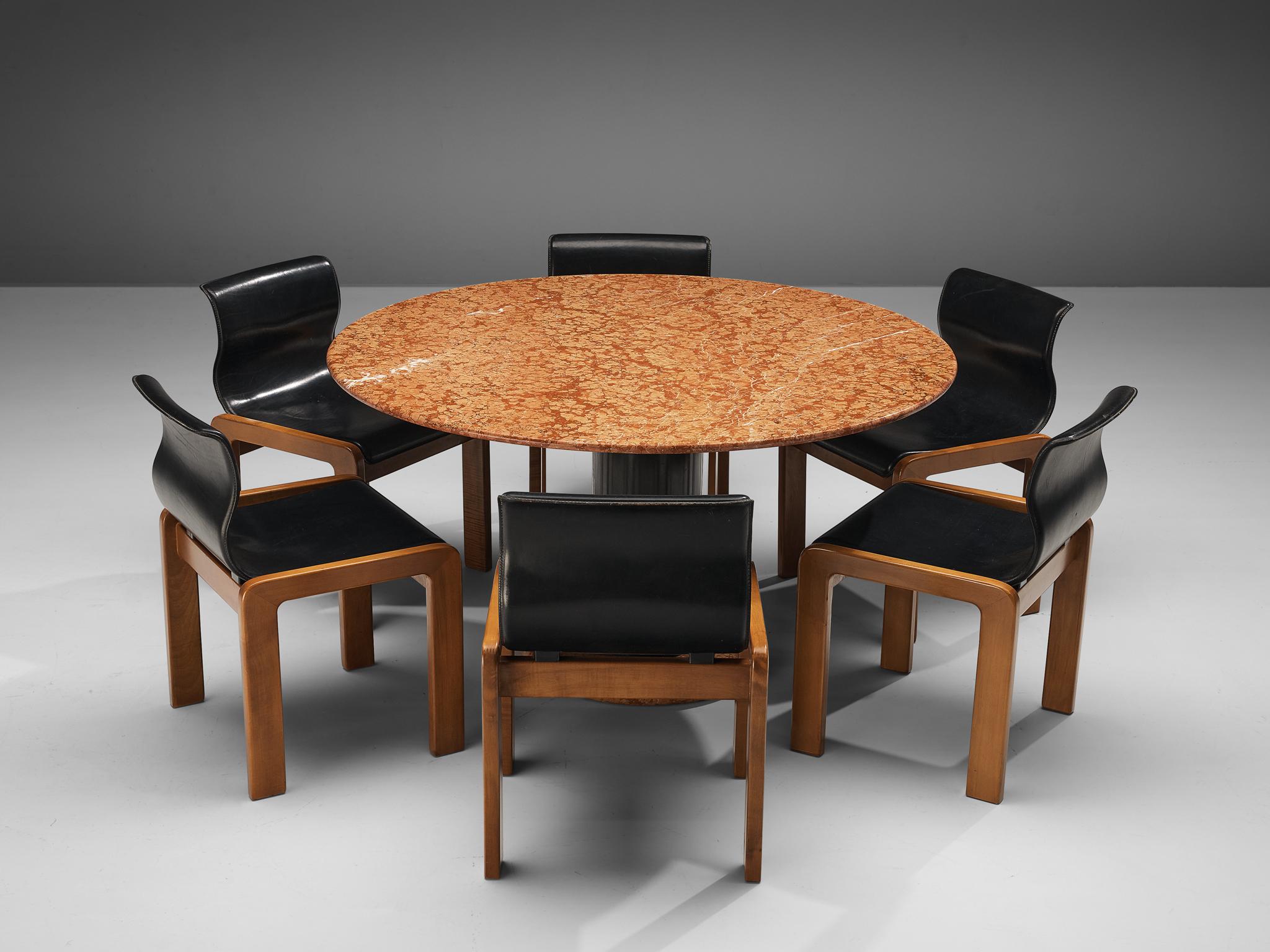 Set of six dining chairs, leather and walnut, Italy, 1970s.

A set of six cubic dining chairs with a distinctive curved backrest. These chairs are made with a frame with lacquered walnut wood. The chairs have a dent seat that curvaciously flows