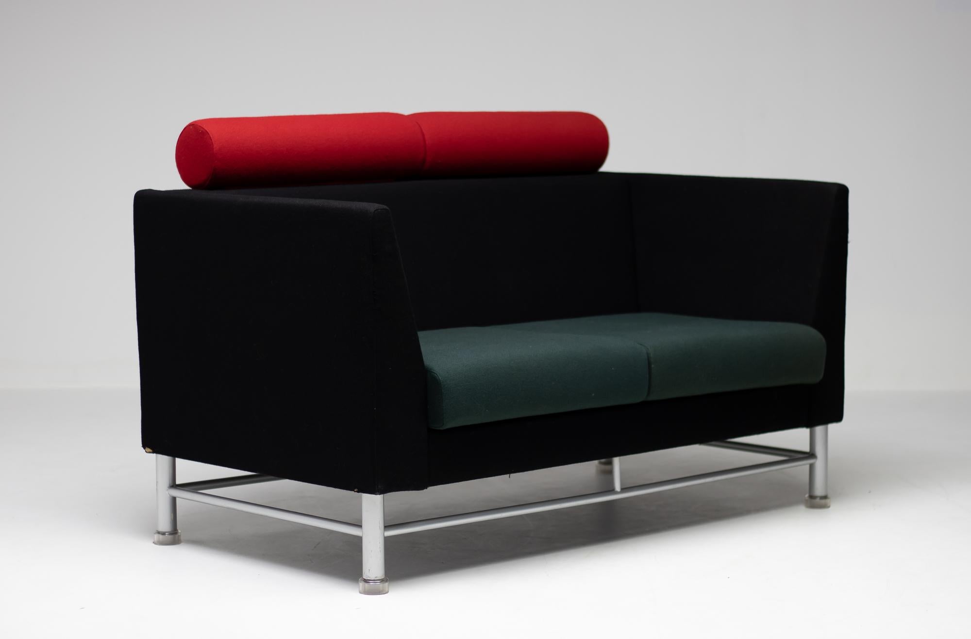 East side sofa designed by Ettore Sottsass for Knoll International in 1983. Postmodern sofa with its original upholstery in nice vintage condition. The sofa features a gray enameled steel base with translucent plastic feet.
The sofa will be shipped