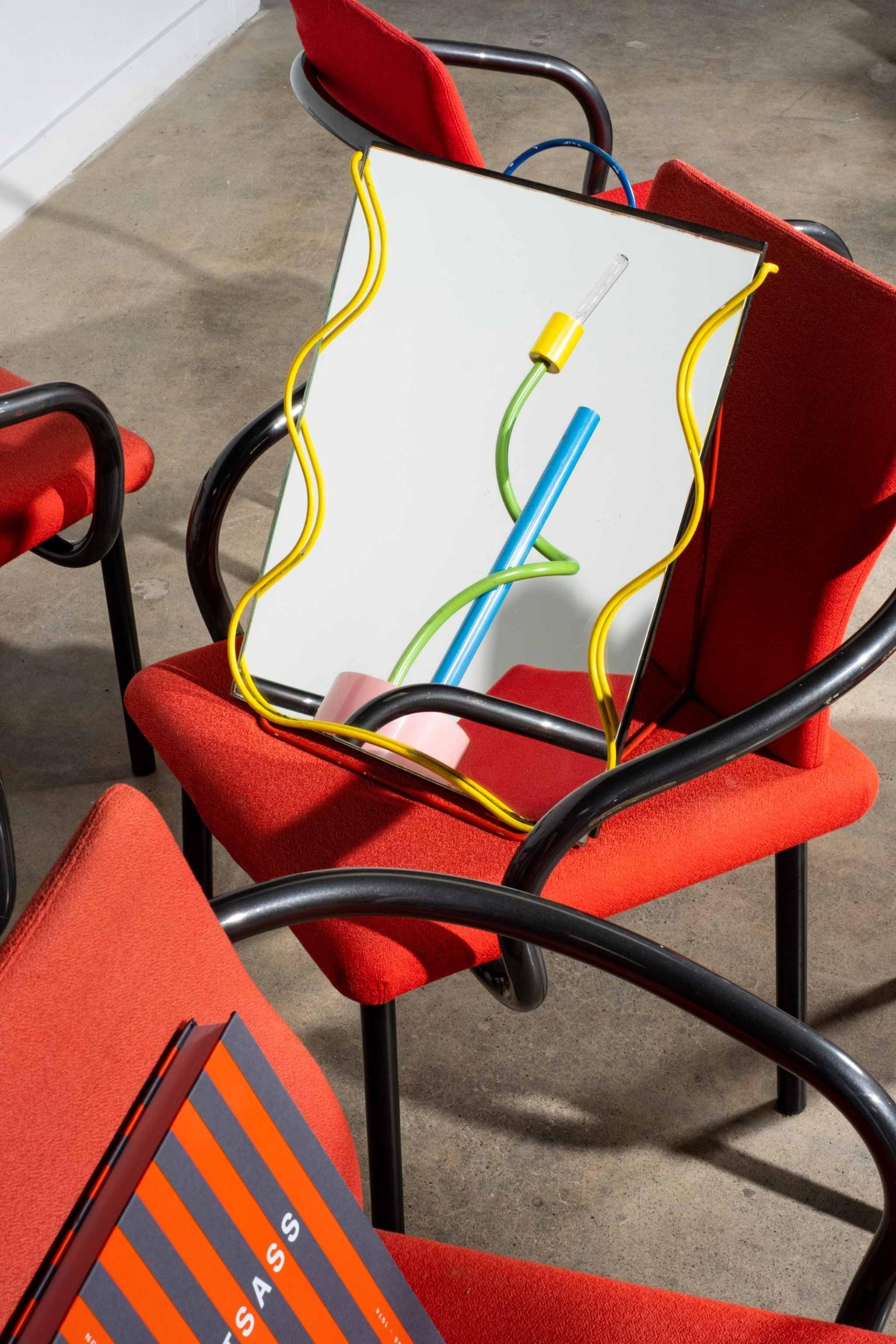 Conceived by Italian architect and designer, Ettore Sottsass and manufactured in 1986 by Knoll, the Mandarin chair is a highly functional design with distinctive one-piece arm-rail that wraps under and around the seats and back. Its sculptural arms
