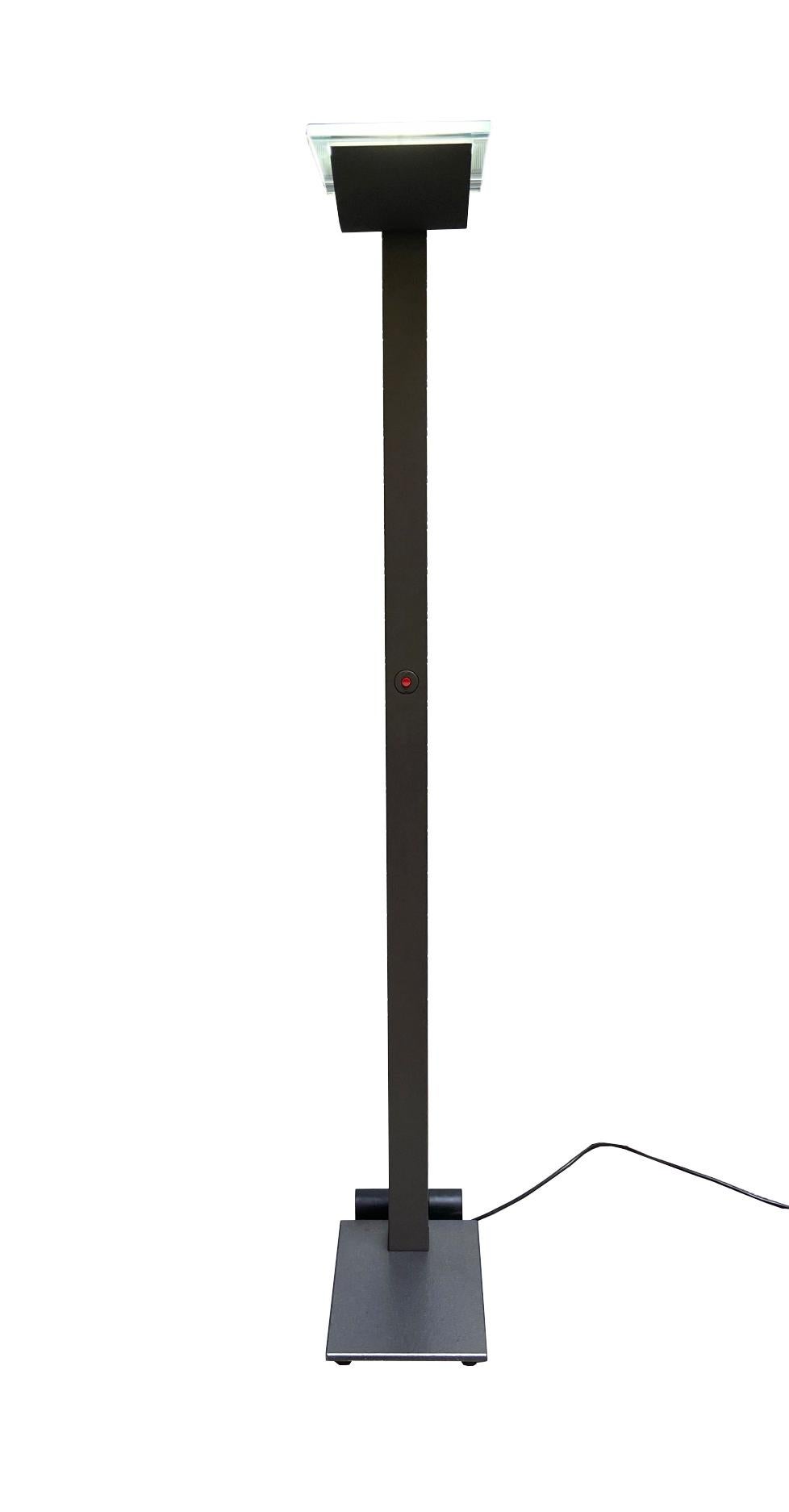 This floor lamp was designed by Ettore Sottsass in the 1980s. This Ettore Sottsass floor lamp model ID-S is produced by the Italian company Staff. The floor lamp has black in color. The lamp is equipped with a swivel filter cap. Ettore Sottsass was