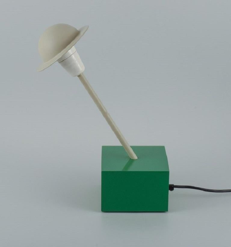 Ettore Sottsass for Stilnovo. 
Rare table lamp in green and gray painted metal.
Approx. 1980s.
In perfect condition.
Sticker.
Max 100 watts.
Base length 14.0 cm.
Total height: 39.0 cm.