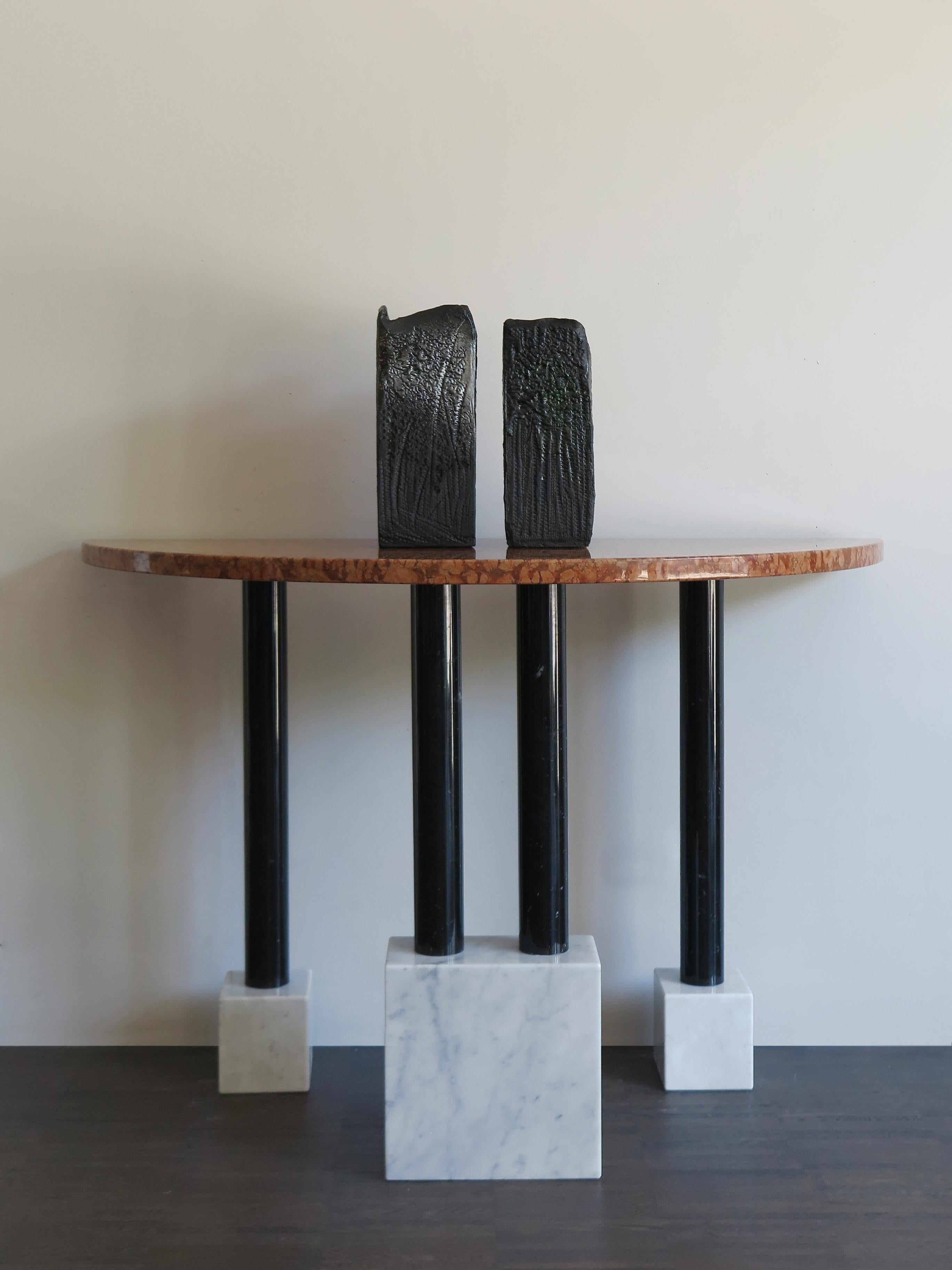 Italian very rare marble console table designed by famous italian artist Ettore Sottsass and produced by Ultima Edizione in limited edition, made up of white Carrara marble blocks, black Marquinia marble columns and red Verona marble top, 1980