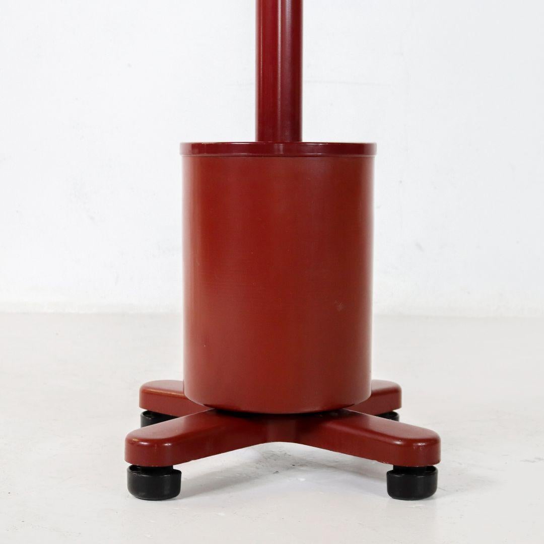 Coat rack by Memphis Milano legend Ettore Sottsass for Olivetti Synthesis. Sottsass designed the coat rack in 1973 as part of the 'Series 45' office furniture program. Cast aluminum base, powder-coated steel shaft and umbrella stand, cast plastic