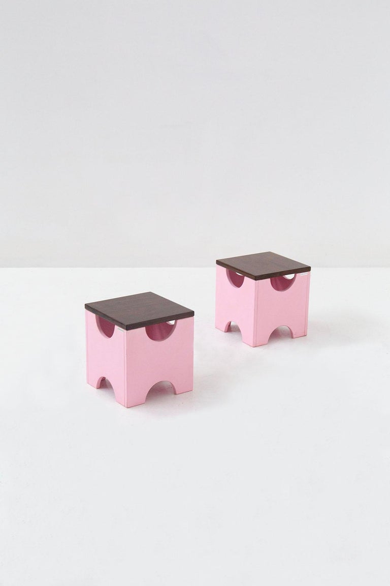 Eccentric pair of stools designed by the great designer Ettore Sottsass for the Poltronova manufacture in 1963. The sbagelli are model T29 also called Dado. Resenta product label. The stools are made entirely of wood, with acid PINK lacquered wood