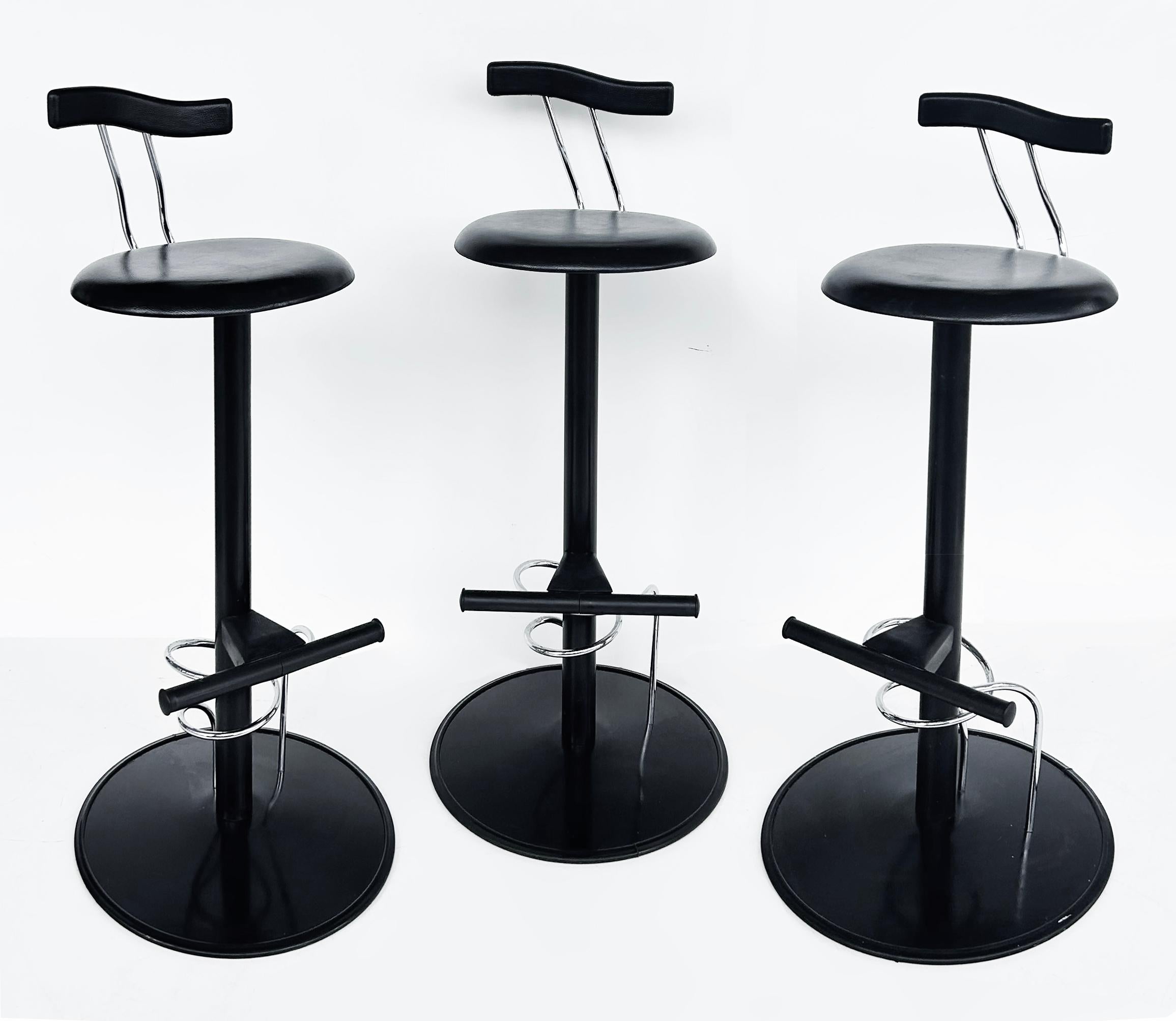 Ettore Sottsass Post-Modern Memphis Milano Style Bar Stools - Set (3)

Offered for sale is a set of three post-modern Memphis Milano-style bar stools designed by Ettore Sottsass.  Made of black lacquered steel with black molded rubber seats and